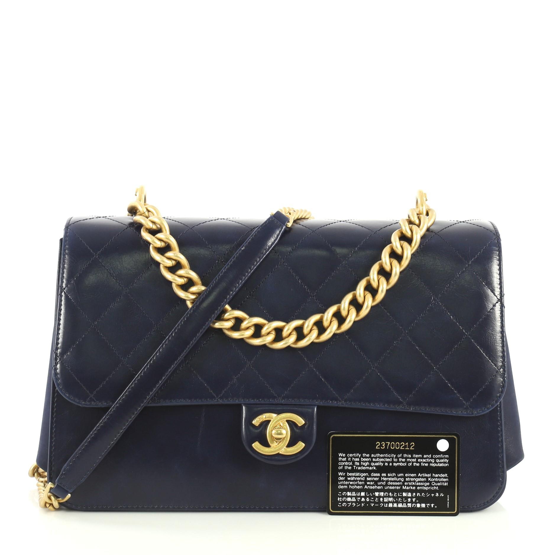 This Chanel Paris Cosmopolite Straight Lined Flap Bag Quilted Aged Calfskin Medium, crafted in blue quilted aged calfskin leather, features chain link handle, chain link strap with leather pad, exterior back slip pocket and aged gold-tone hardware.