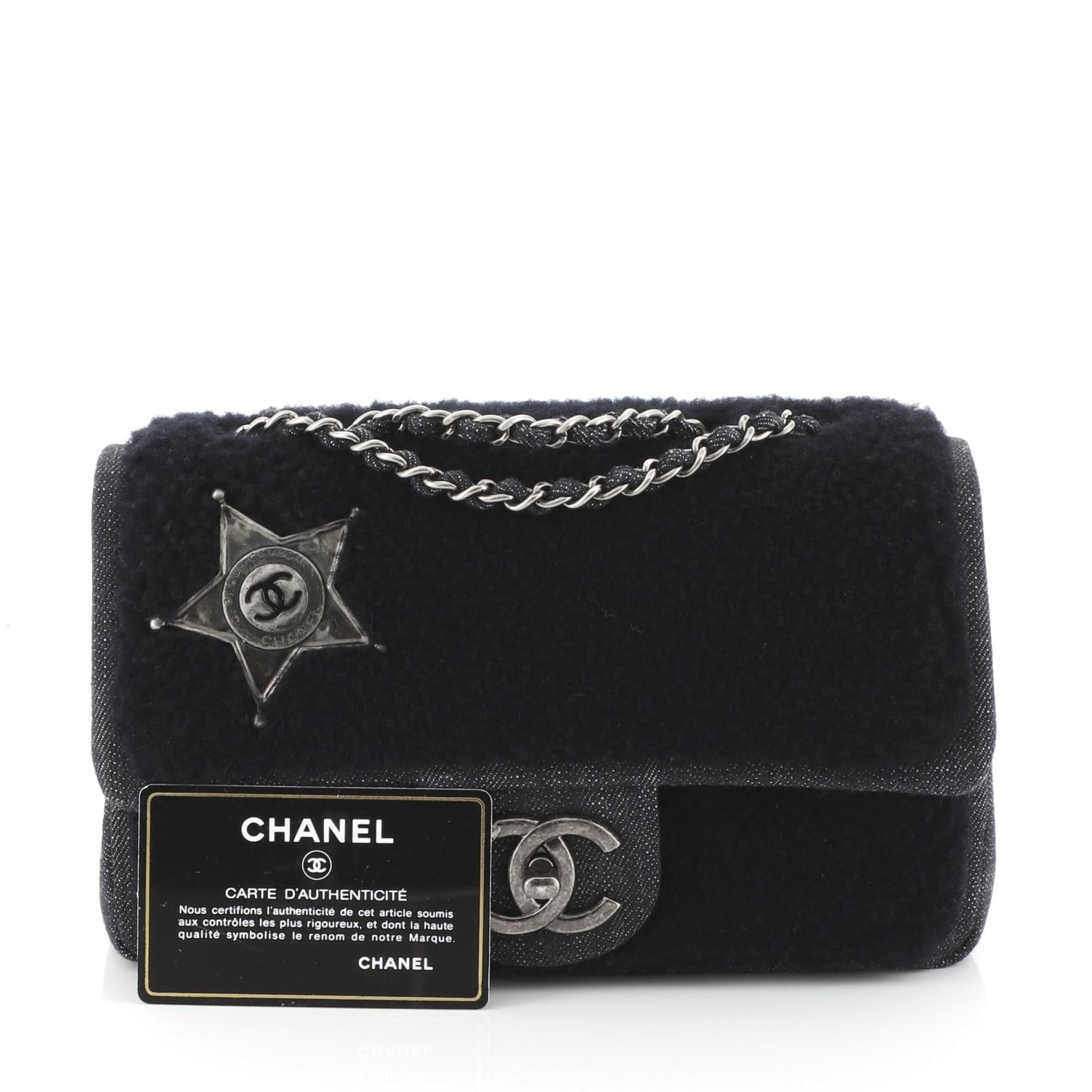 This Chanel Paris-Dallas Flap Bag Denim and Shearling Small, crafted from blue denim and shearling, features woven-in denim chain strap, interlocking CC logo at front, and aged silver-tone hardware. Its CC turn-lock closure opens to a red leather