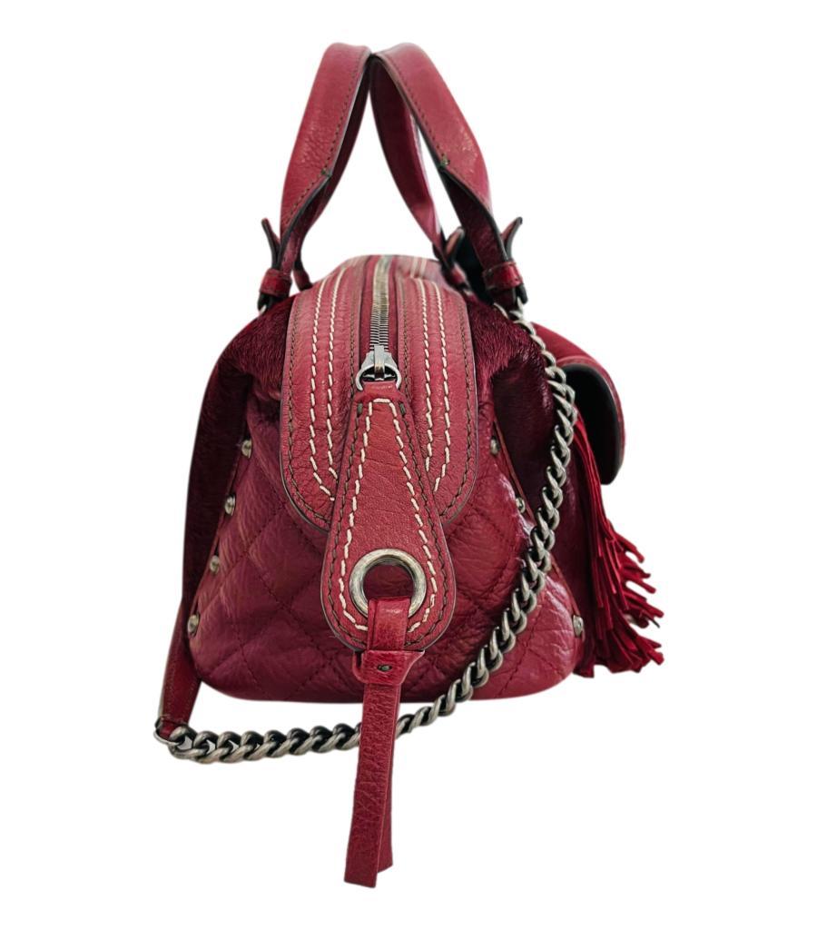 Rare Item - Chanel  Paris-Dallas Pony Hair & Leather Fringe Bag
Burgundy handbag crafted in pony-hair with diamond quilted leather sides.
Detailed with leather fringe to the front with mini flap pocket detailed with 'CC' turn lock closure.
Top