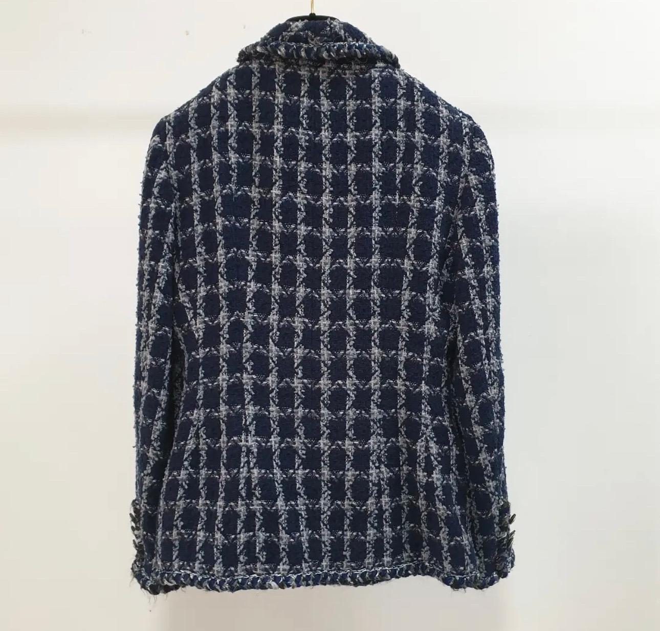 From the Pre-Fall 2014 Métiers d’Art Collection.
Blue Chanel tweed jacket with star-studded trim, tie detail at neck, long sleeves, two pockets and front zip closure.
Sz.42
Very good condition.

