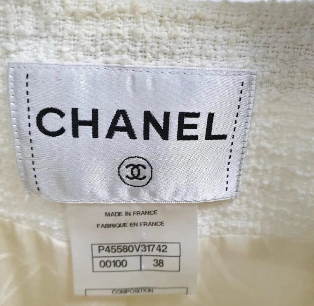 Chanel Paris - Dallas white tweed jacket with blue ribbed inserts. CC logo ruthenium buttins with stars.
100 cotton fully lined in silk with Camellia patterns.
Chanel logo and brand buttons
2 Patch pockets. There are traces of makeup powder on the