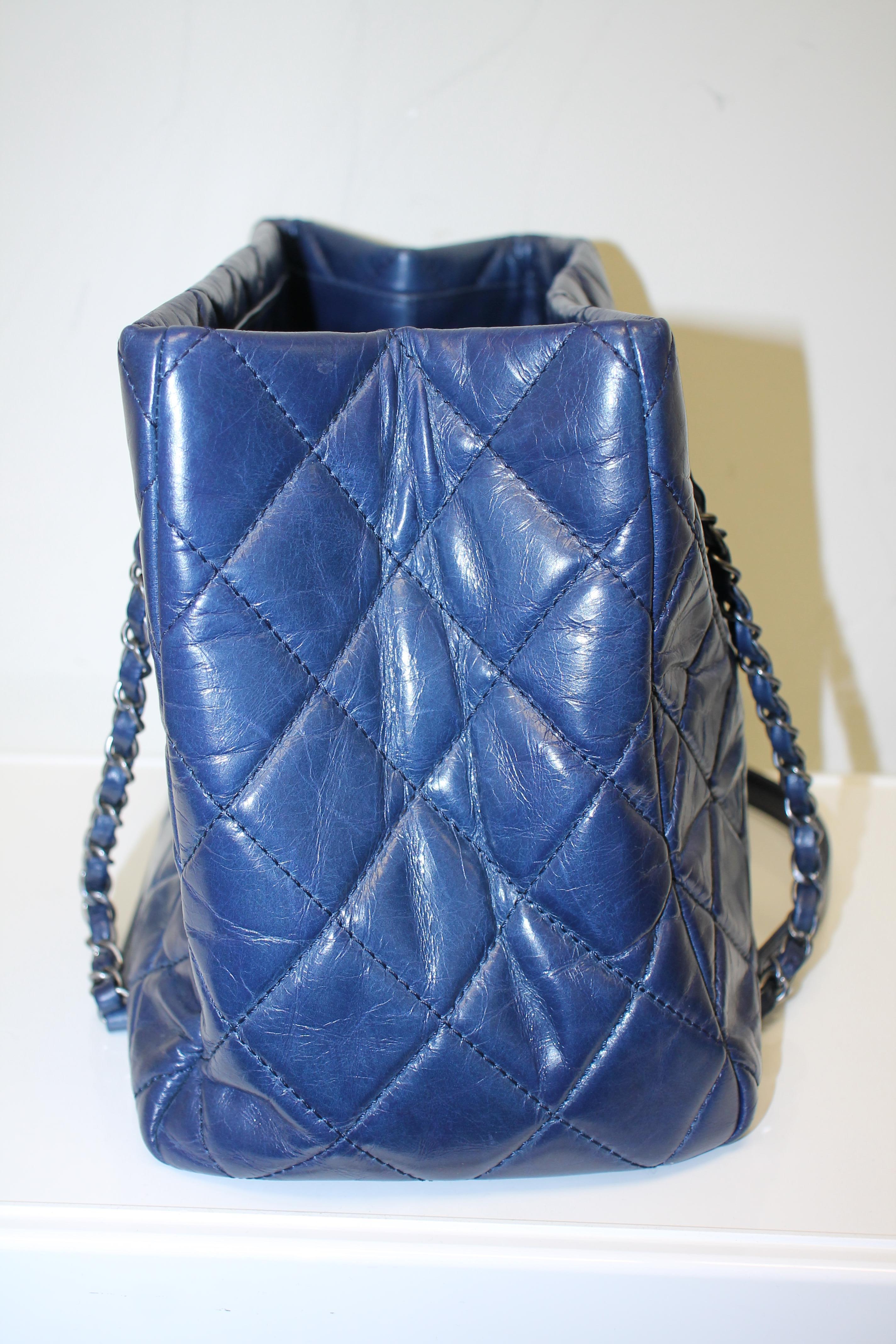 ​From the 2015 Cruise Collection. Navy quilted aged calfskin leather. Antique silver-tone hardware. Opened top. Dual chain-link and leather straps with leather shoulder pad. 