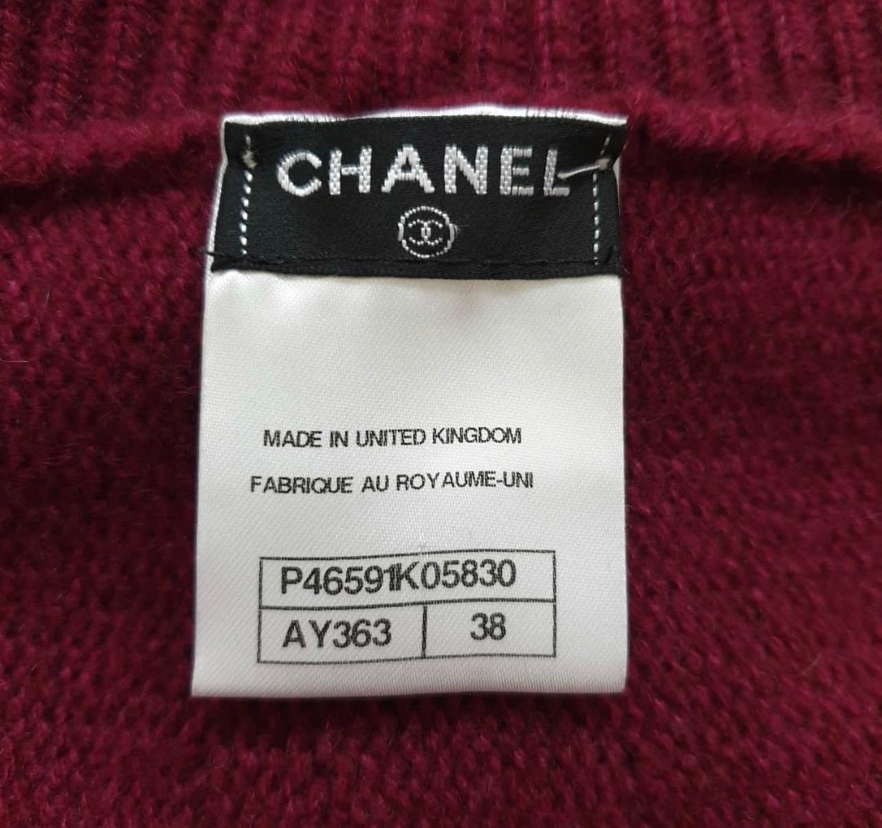 From the Pre-Fall 2013 Métiers d’Art Collection. 
Dark red Chanel cashmere cape with button accents at top, rib knit turtleneck and tweed trim at arm openings.
Sz. 38
For buyers from EU we can provide shipping from Poland. Please demand if you need.