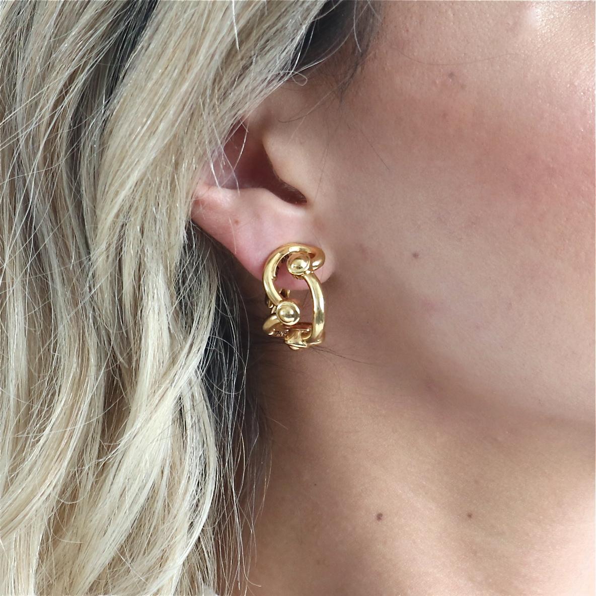 These beautiful Chanel Paris 18k yellow gold earrings feature an abstract design with clip on closures. The total weight of the pair is 22.5 grams. Signed Chanel and includes serial number. Circa 2000s. 13/16 inches x 1/2 inch. Stamped with French