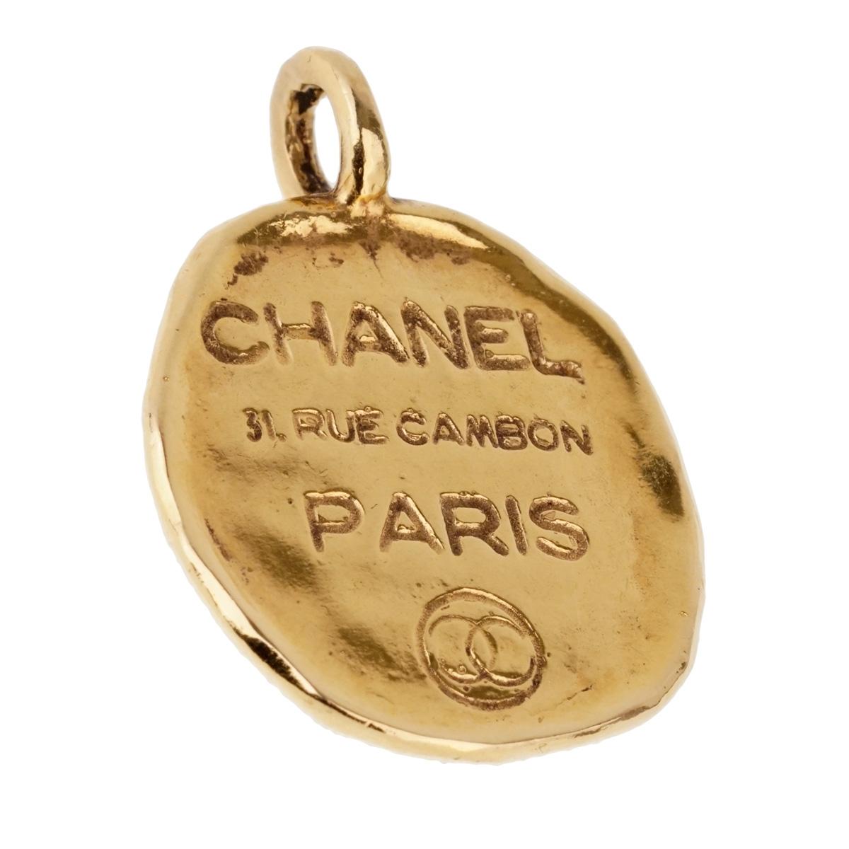 A vintage Chanel pendant engraved with the house of Chanel's address 31 Rue Cambon Paris in 18k yellow gold.