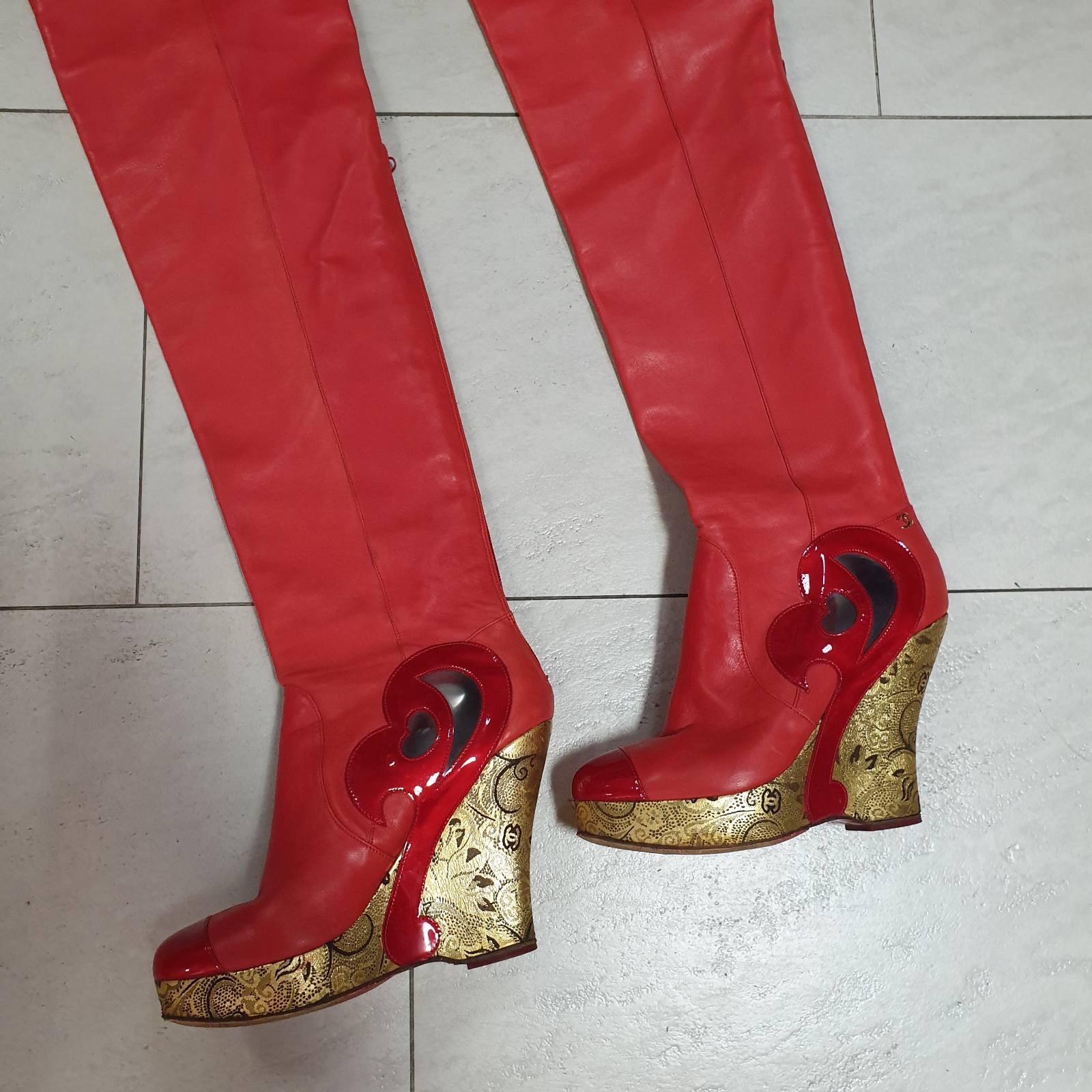 From the Pre-Fall 2009 Runway Collection. 

Red leather Chanel Paris-Moscow thigh-high cap-toe boots with rounded toes, metallic gold perforated leather lace covered platforms and wedge heels, PVC and patent leather trim, and back zip closure. 
Sz.