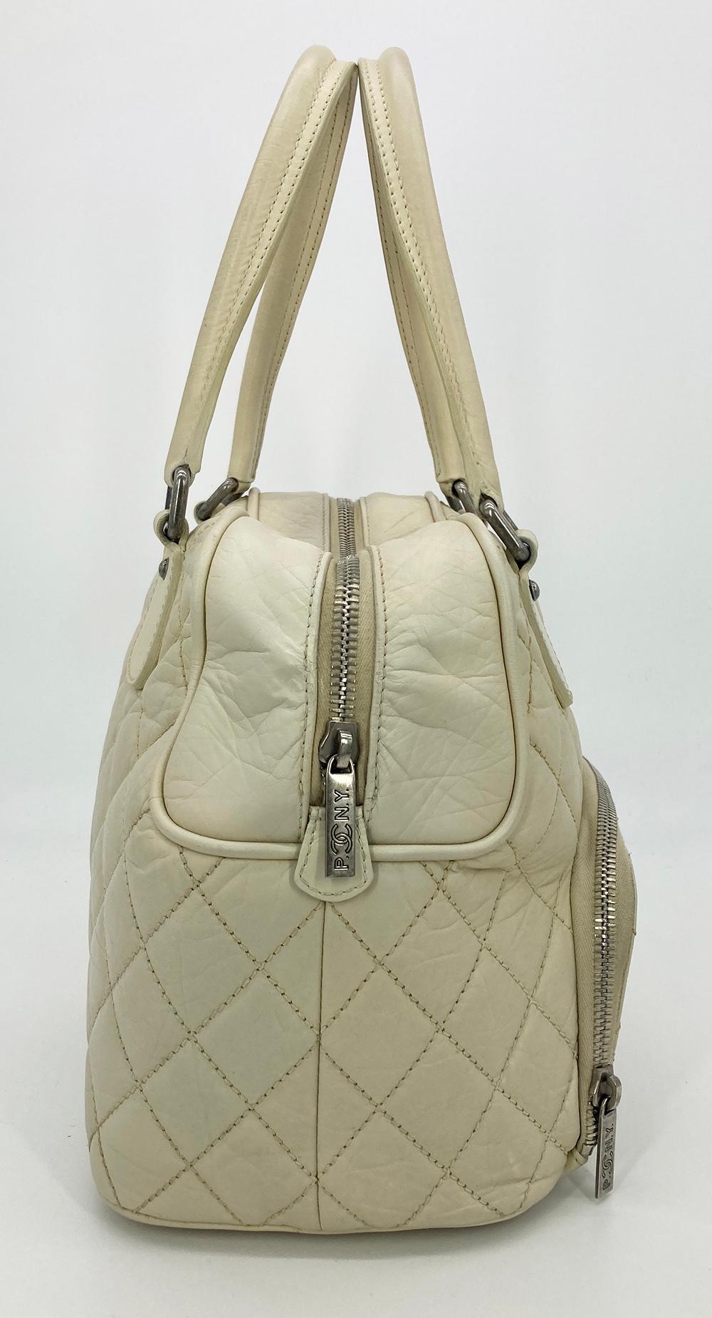 Chanel Paris New York Cream Distressed Bowling Tote in very good condition. Clean corners and edges. one stain inside on bottom lining and some wear on lining around ends of zipper inside. see photos. otherwise excellent condition. unique and rare