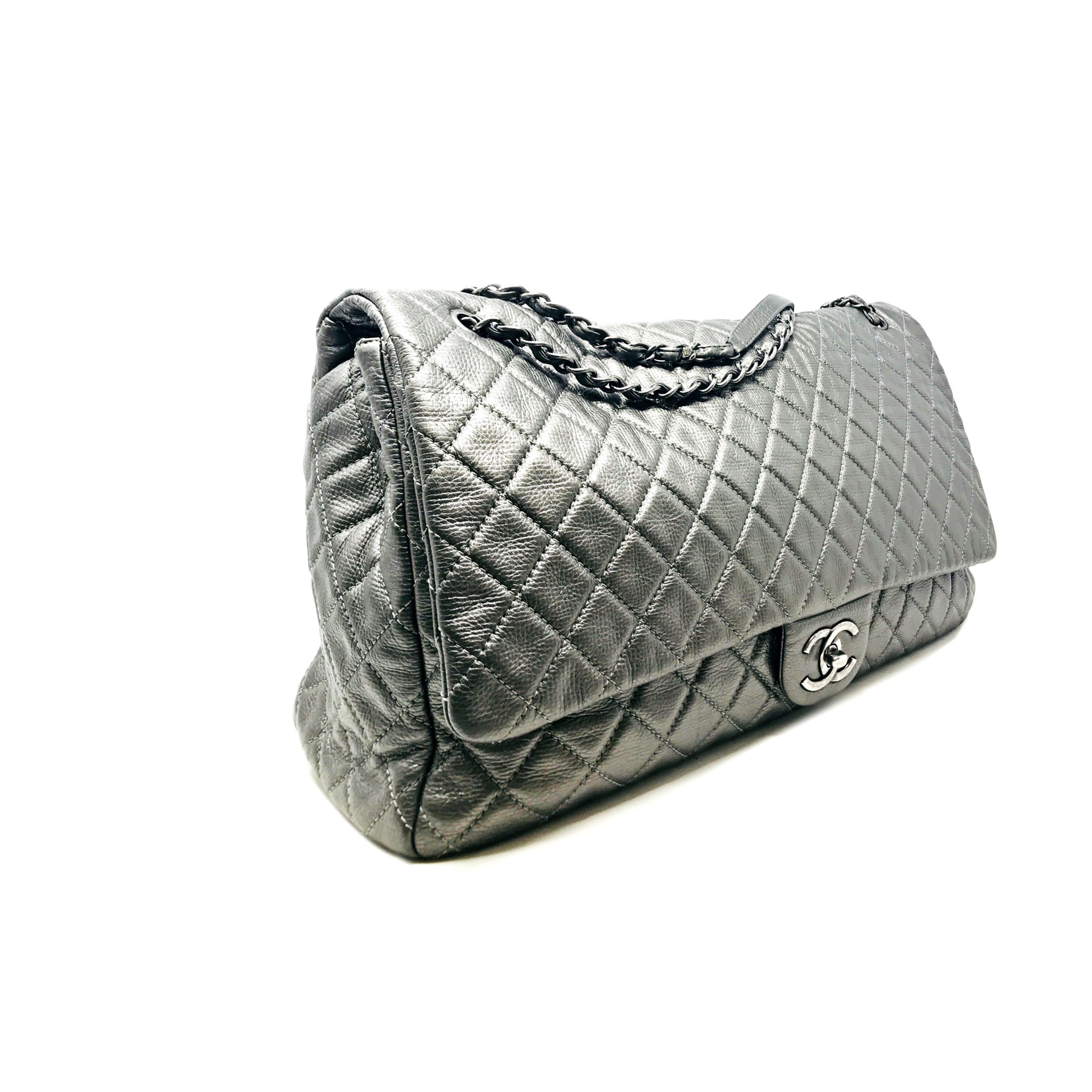 CHANEL PARIS XXL BAG His Weekender bag from Chanel in a silver leather  will make you forget all the other bags you have seen or liked. It is spacious and durable and is crafted from leather  with the signature quilted pattern.  The interior of the