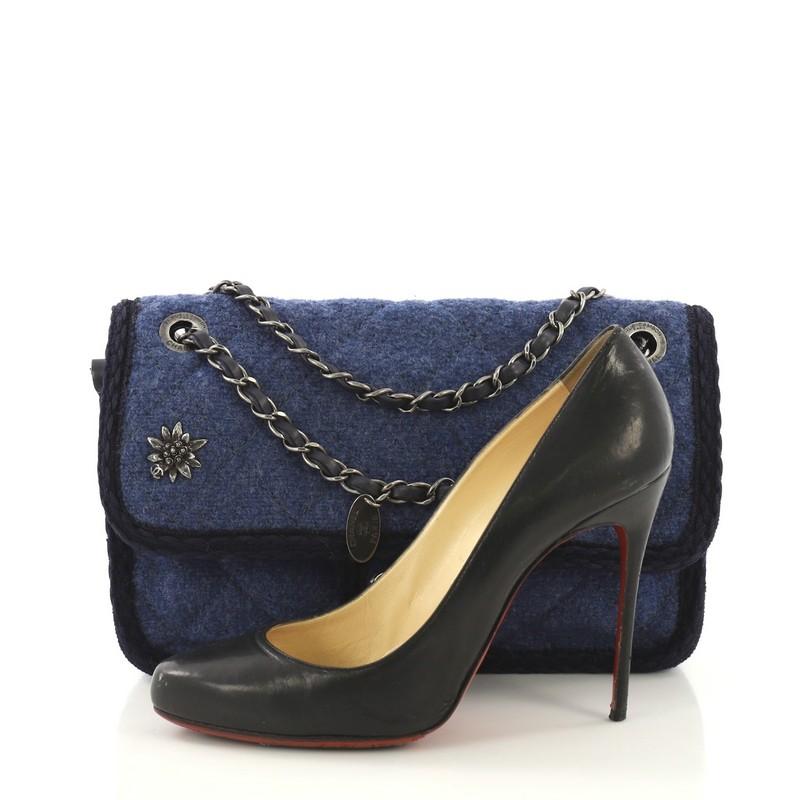 This Chanel Paris-Salzburg Flap Bag Quilted Wool Small, crafted from blue quilted wool, features woven-in leather chain strap, CC embellished floral adornment at front, and aged silver-tone hardware. Its CC turn-lock closure opens to a burgundy