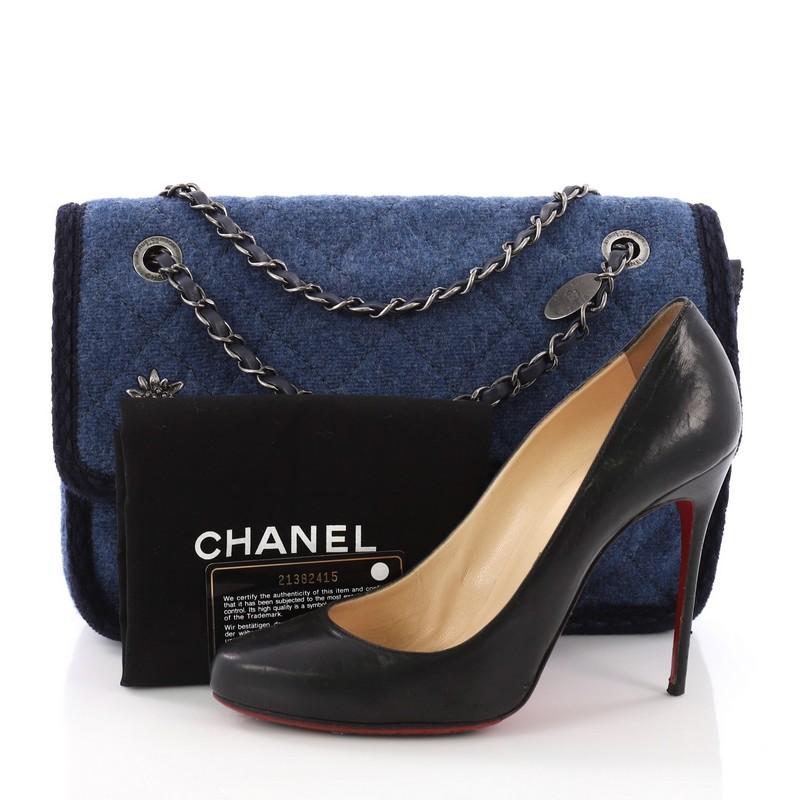 This Chanel Paris-Salzburg Flap Bag Quilted Wool Small, crafted from blue quilted wool, features woven-in leather chain strap, CC embellished floral adornment at front, blue stitching throughout the edges, and aged silver-tone hardware. Its CC