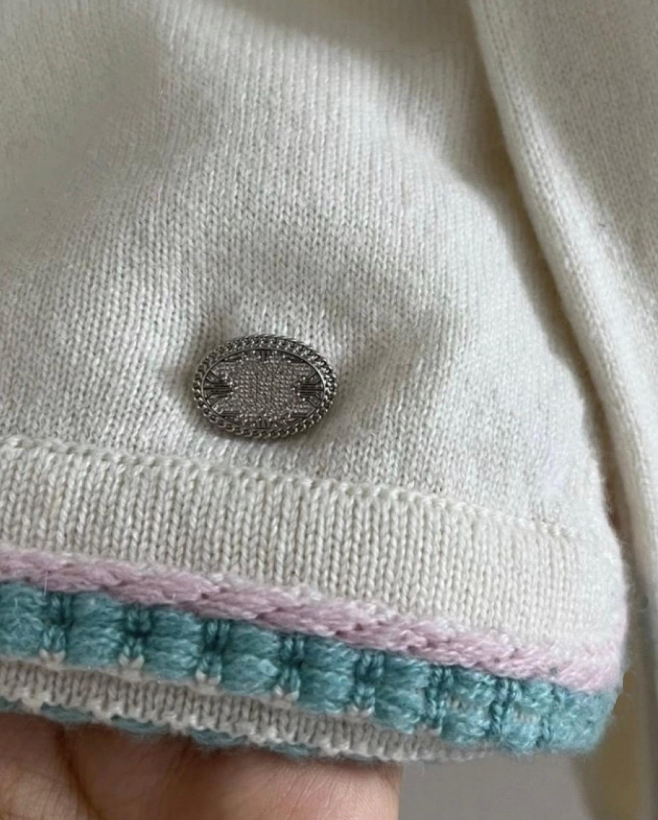 Chanel ecru cashmere jumper from Paris / SEOUL Cruise Collection
- CC logo charm at side
Size mark 42 FR. Pristine condition.