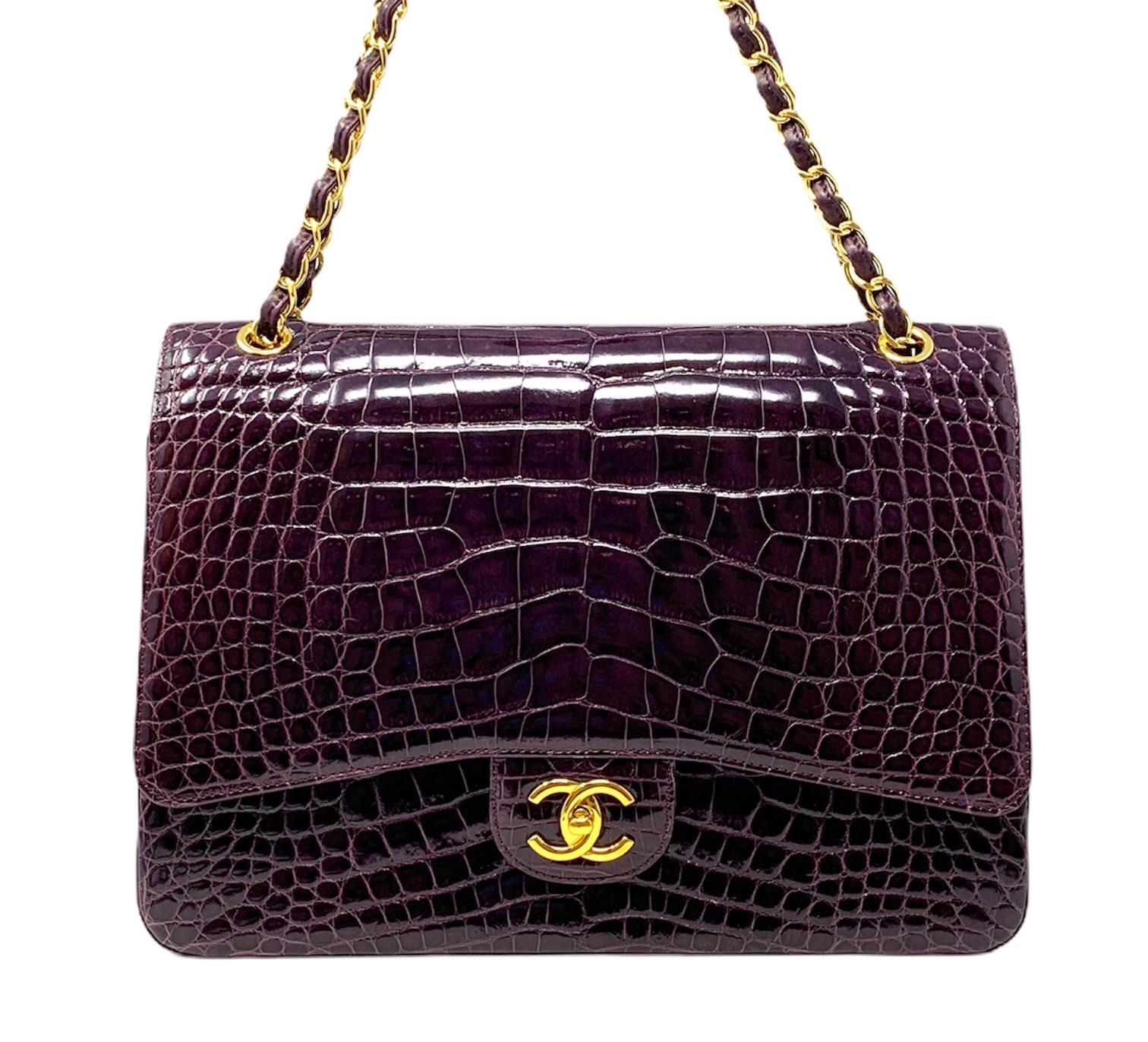 Extremely Rare and amazing Exotic Chanel Bag Maxi Jumbo Classic Timeless Bag with double flop in Shine Purple Croccodile Heather with elegant Hardware gold. This bag features a front flop with a Classic Gold Turnlock CC segnature colture, a mid-mono