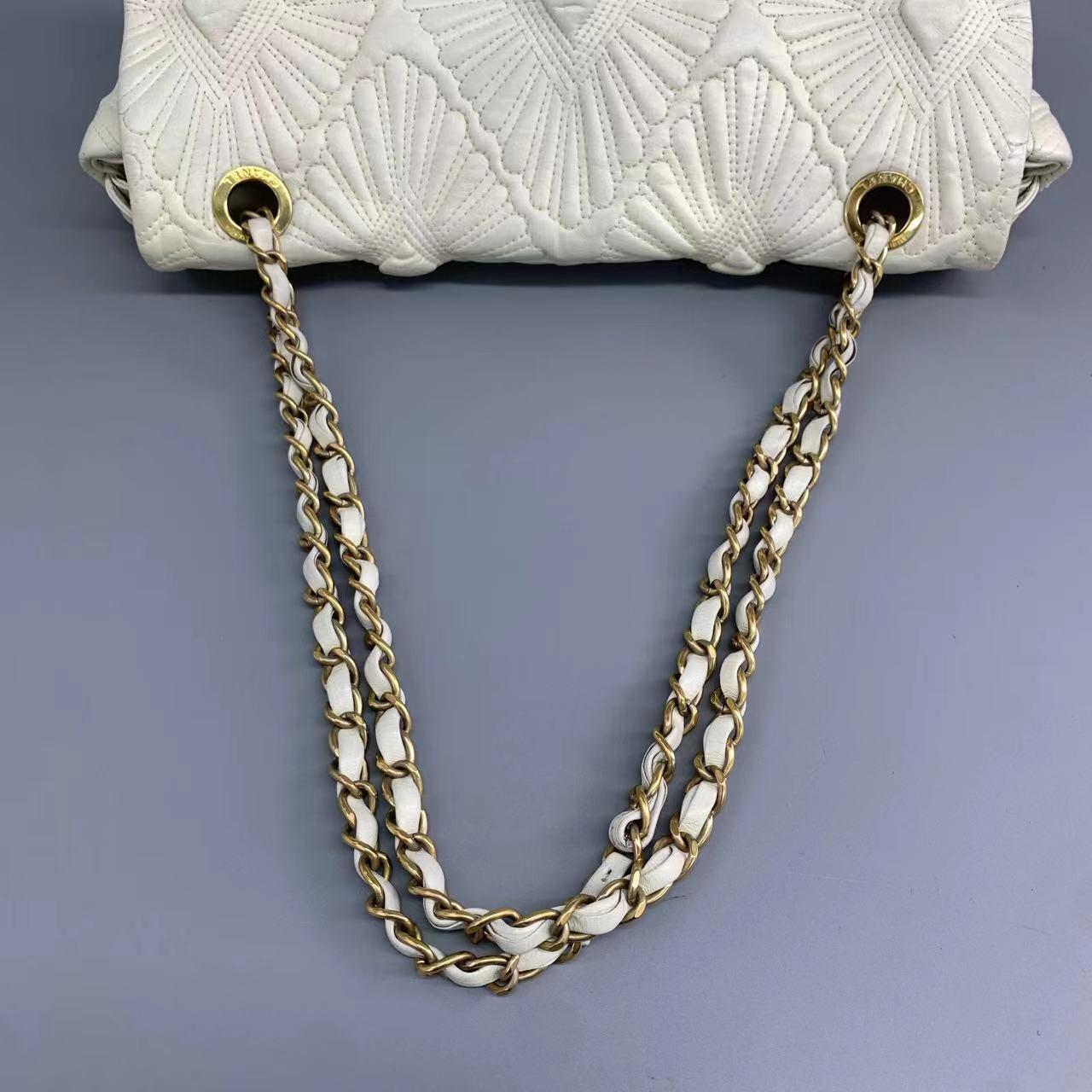 Chanel Paris-Venice Ca D‚ÄôOro Flap Bag Seashell 3D Embroidered Flap Bag 2009 Large Off White

This item is a genuine CHANEL Lambskin Quilted Ca D'Oro Flap in Off White. The elegant handbag bag is exquisitely crafted from soft lambskin leather and