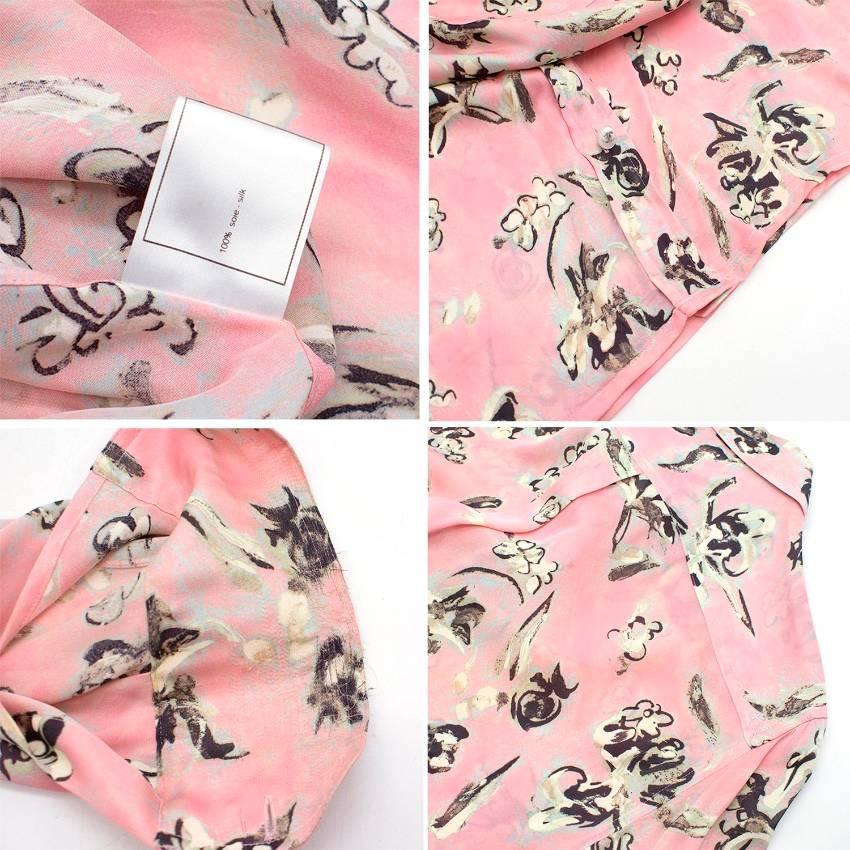 Chanel Pastel Pink with Flower  Print Silk Blouse featuring an abstract illustrated print by Chanel designed by Karl Lagerfeld in the 1990s, Chanel logo button closure, flower print and long sleeves. Made in France.

Fabric: 100% silk.
Colour: Pink.