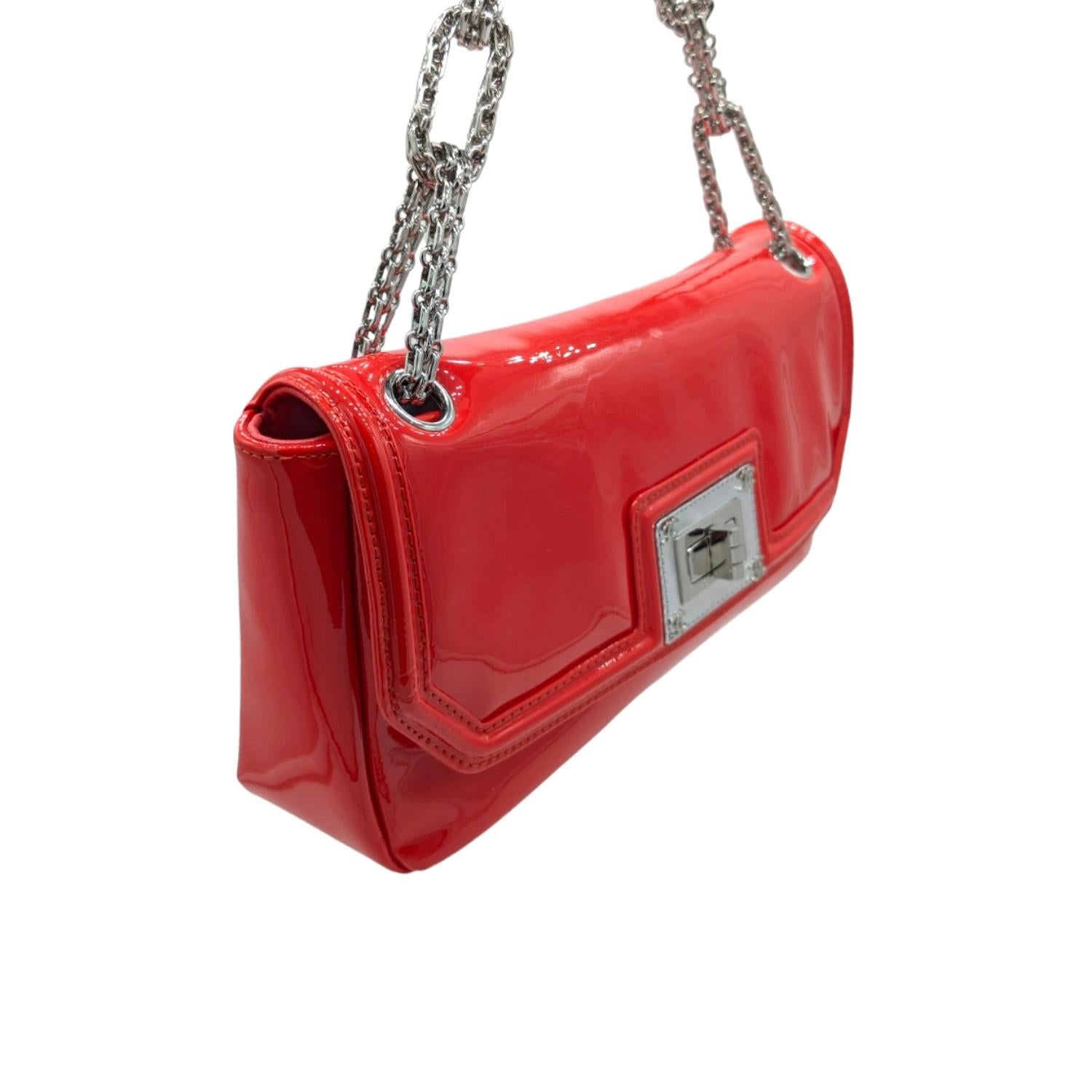 From the 2008-2009 Collection by Karl Lagerfeld. This stylish shoulder flap bag is crafted of patent calfskin leather in bright red. The bag features a silver Bijoux chain-linked shoulder strap and a silver squared Mademoiselle turn lock. This opens