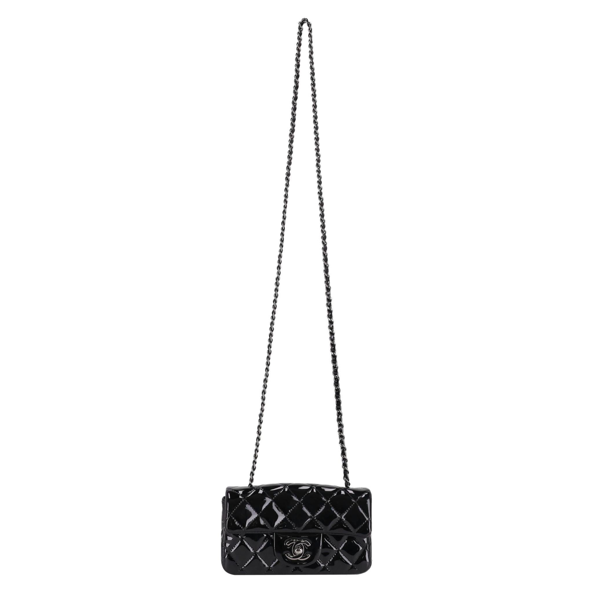 Investment Piece - Chanel Patent Calfskin Quilted Extra Mini Flap Bag On A Chain

Shiny black crossbody bag crafted of patent leather in iconic diamond quilted pattern.

Featuring silver hardware with 'CC' turn-lock closure to the front flap leading