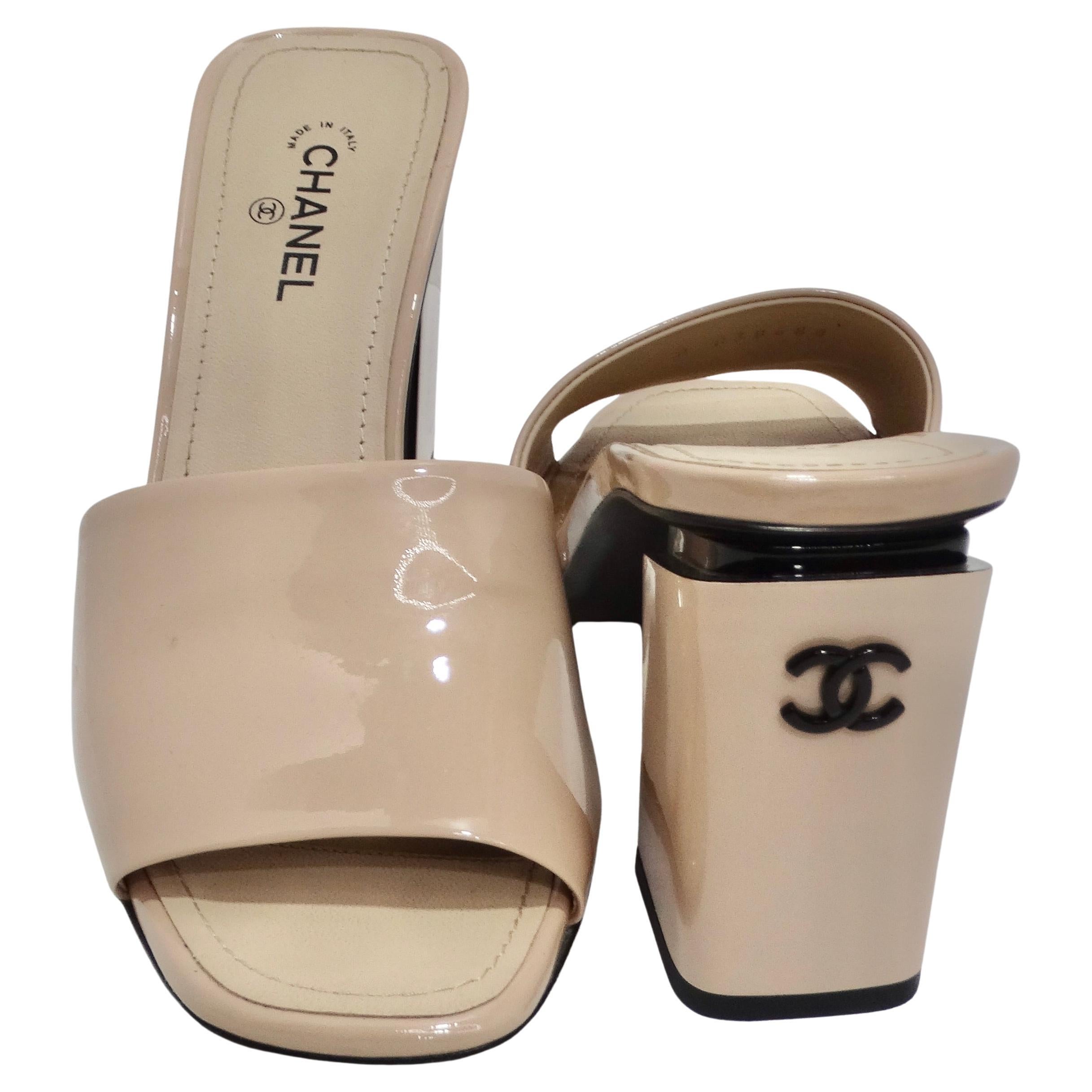 
Elevate your footwear collection with these authentic CHANEL Patent CC Mules, a harmonious blend of sophistication and style. These exquisite slide mules are expertly crafted from high-quality beige patent leather, showcasing Chanel's unwavering