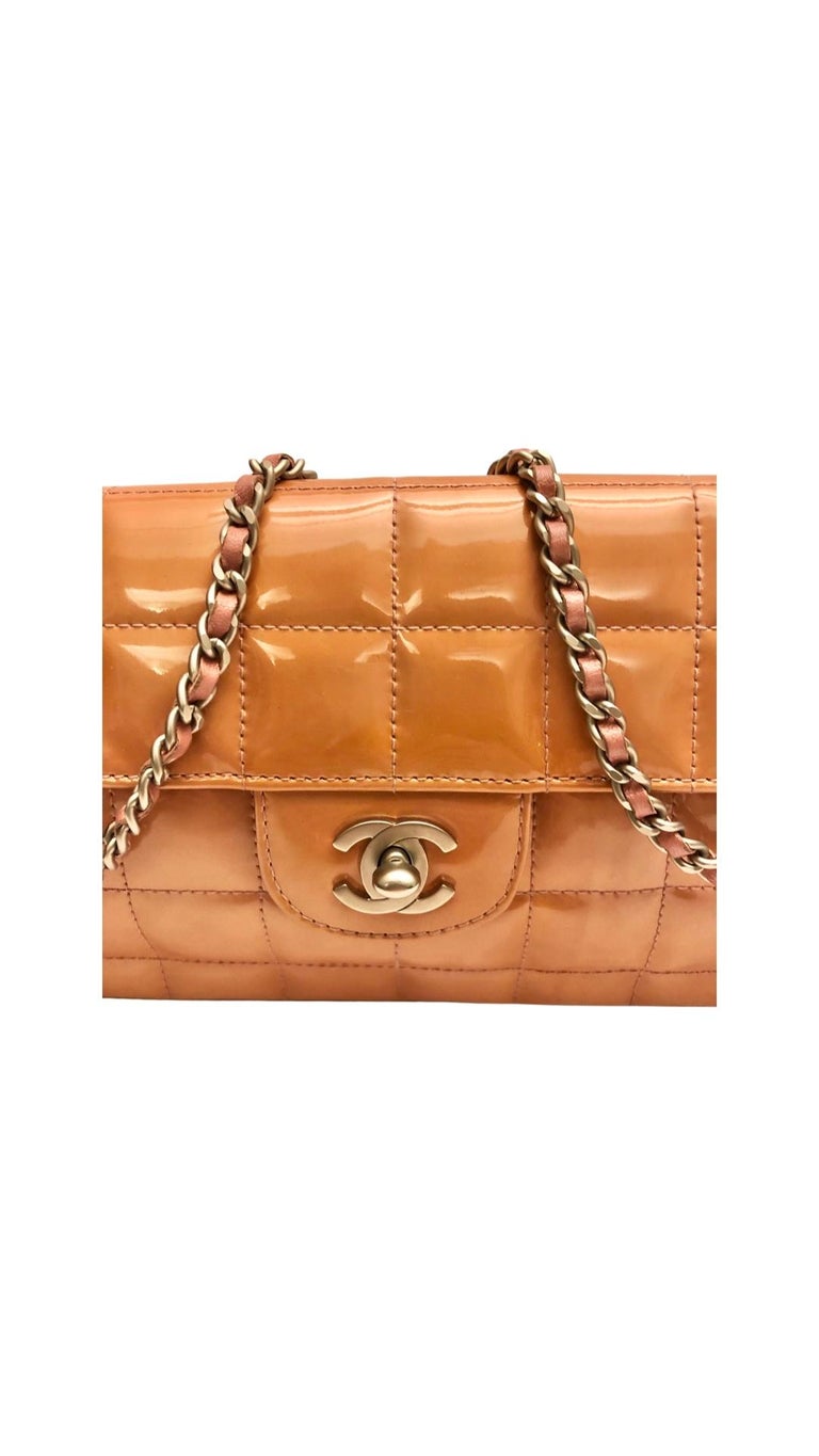 - Chanel Patent Chocolate Bar Flap Shoulder Bag from year 2000-2002 collection. 

- Pink patent leather and silver hardware chain strap. 
 
- Pink leather interior. 

- Two interior slip pockets. 

- Silver hardware CC turnlock closure. 

- Come
