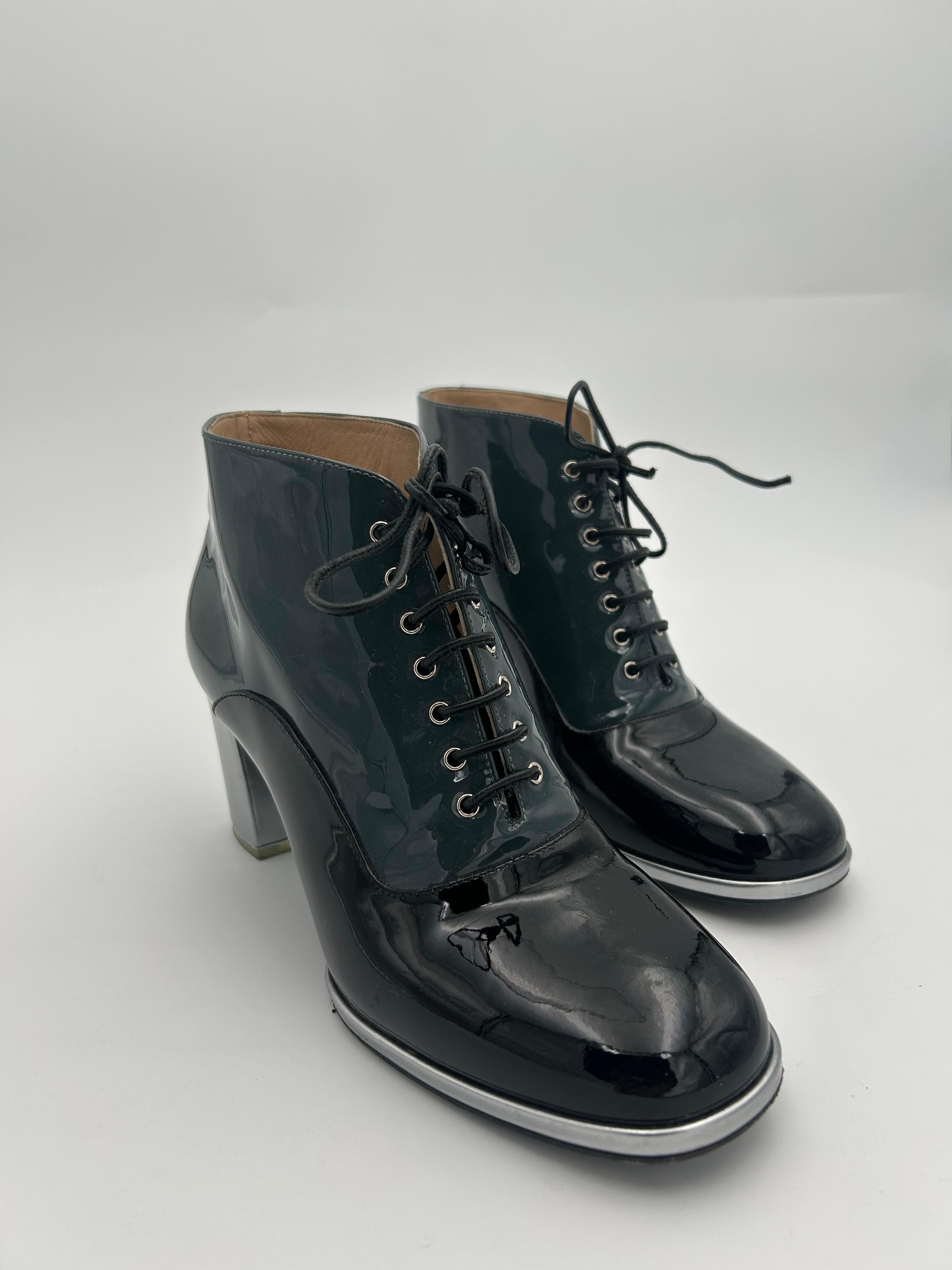 Chanel Patent Leather Ankle Heels Boots. Beautiful and classy Chanel mid-size boots in pristine condition.  The patent leather is in perfect shape and adds a touch of originality to this pair of boots. On the bottom of the heel can be seen a Chanel