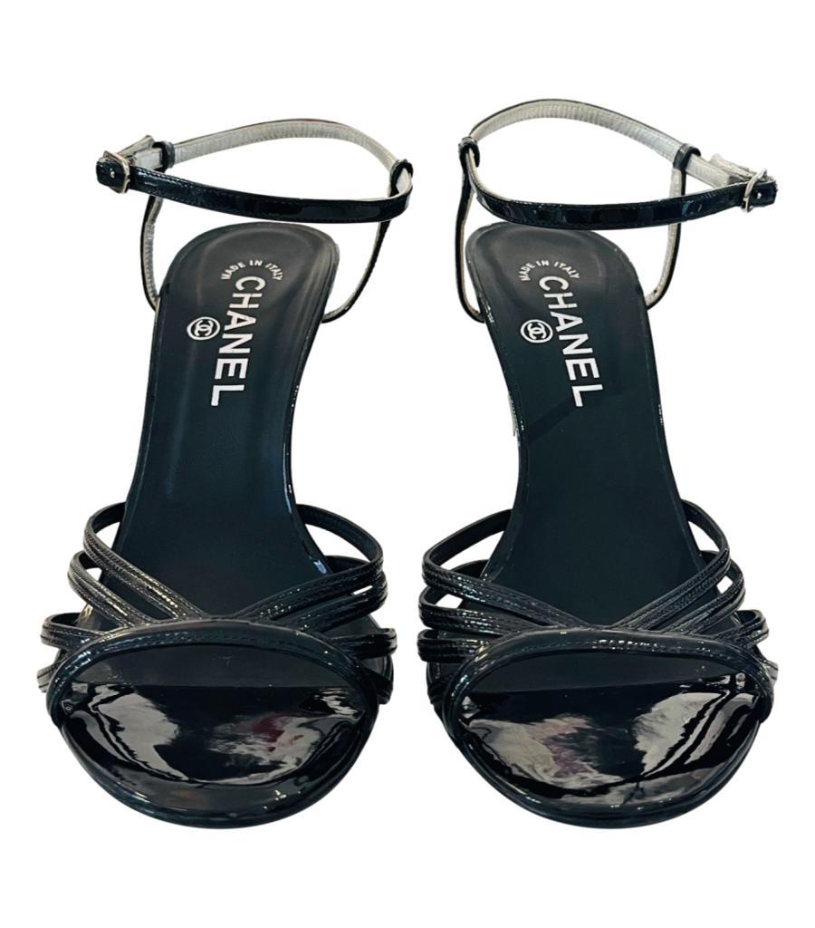 Chanel Patent Leather Sandals With Metallic 'CC' Logo Heel

Black strappy sandals designed with silver detailed cone heel embellished with 'CC' logo engravement.

Featuring adjustable ankle strap and open toe.

From Resort 2010 Collection.

Size –