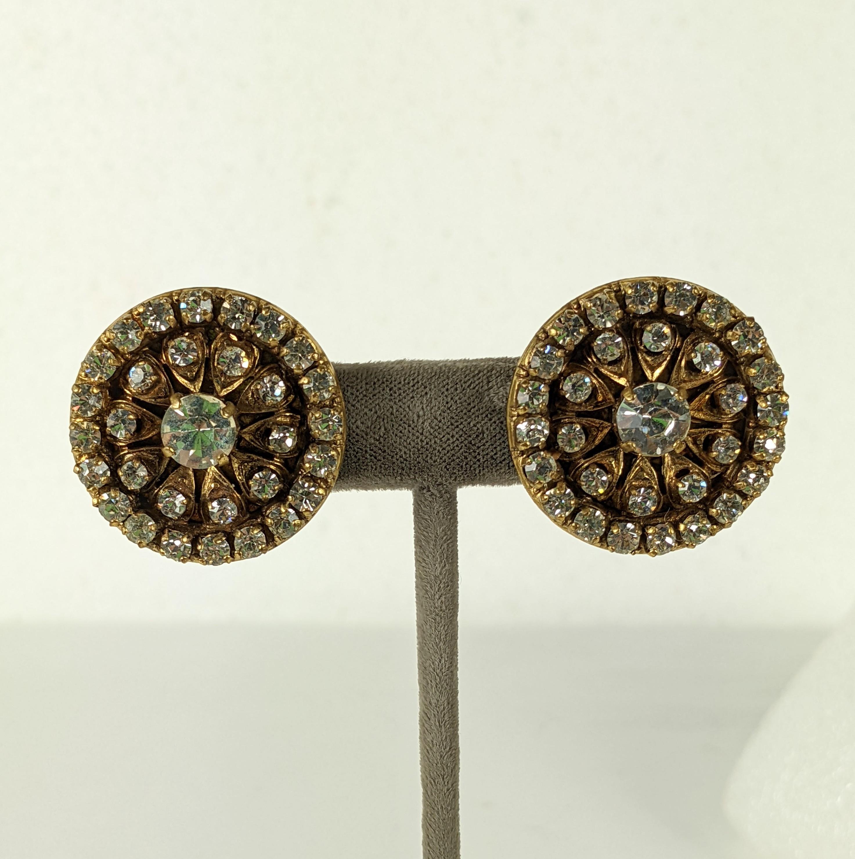 Chanel Pave Encrusted Earrings from the 1990's. Vari sized Swarovski crystals are set in on a round filigree backing in antiqued gold bronze. Clip back fittings.  1.25