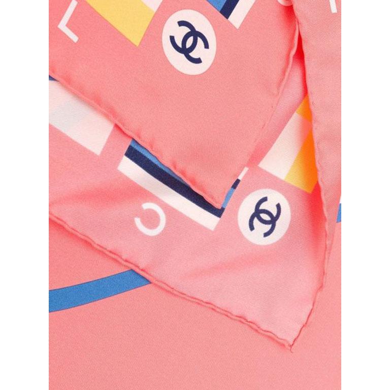 Crafted in Italy from the purest peach-coloured silk, this vintage scarf by Chanel features a central graphic optic white 'Cruise' print motif, which is adorned with the signature interlocking CC logo in a contrasting navy, framed by a