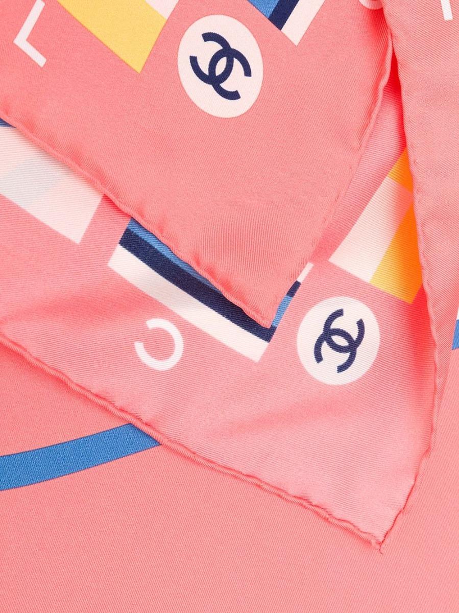 Crafted in Italy from the purest peach-coloured silk, this vintage scarf by Chanel features a central graphic optic white 'Cruise' print motif, which is adorned with the signature interlocking CC logo in a contrasting navy, framed by a