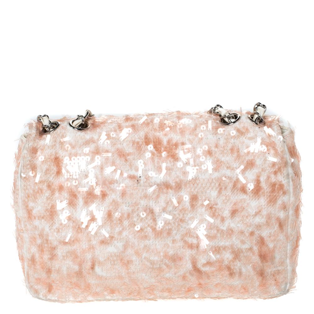 Chanel's flap bags are highly desirable and needless to say, iconic. This Classic Single flap comes made from fabric & sequins and features a woven link, peach & white hues and a CC twist lock in silver-tone. The single flap opens to a leather-lined
