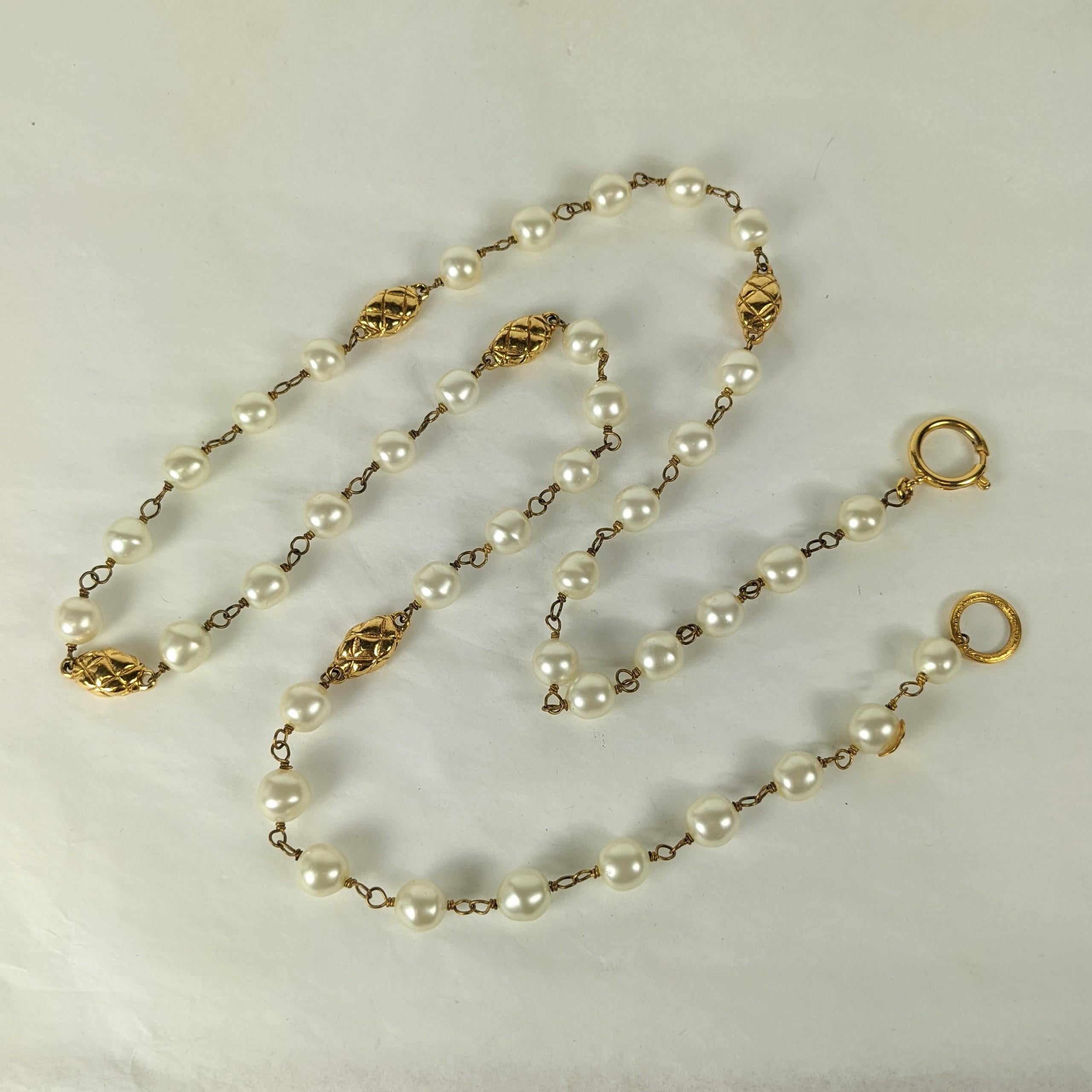 Chanel Pearl and Quilted Bead Chain with wire wrapped Gripoix glass pearls and stations of gilt quilted bronze beads to replicate the quilting on famed Chanel bags.
Versatile with clasp, 36