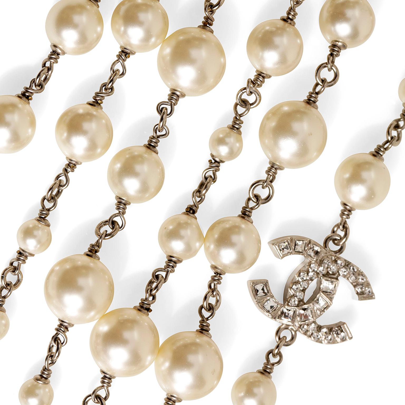 Chanel Pearl and Silver Triple Strand CC Necklace- excellent condition
Three layers of silver twisted chain connects faux pearls in multiple sizes.  Crystal interlocking CC stations.  32 inches long.
