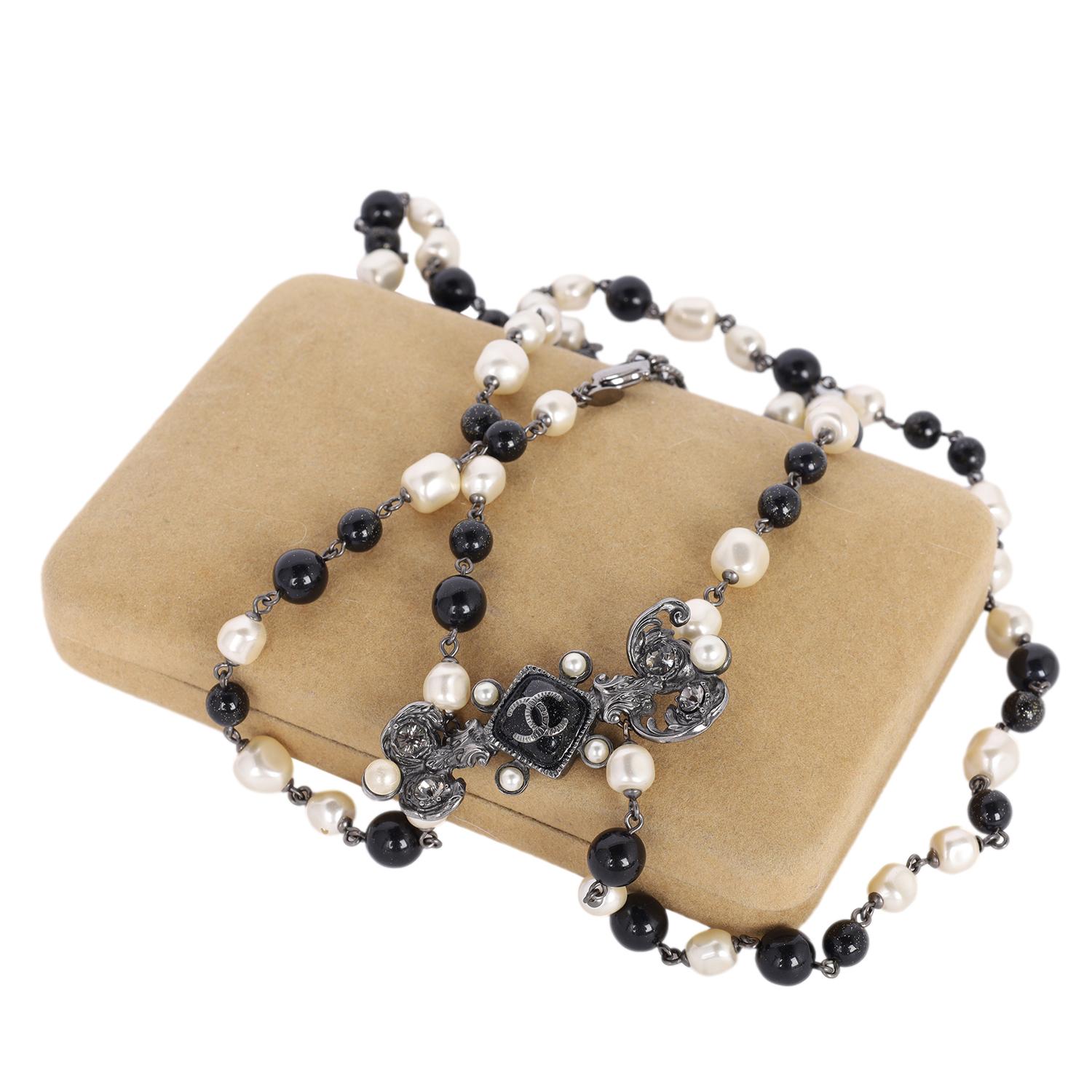 Authentic Chanel Pearl Bead Long Necklace. Features a beautifully detailed Coco Pearl Bead Enamel CC Baroque Long Necklace. This elegant extra long necklace features smooth glass beads, resin baroque pearls, and a textured pendant with a CC logo.