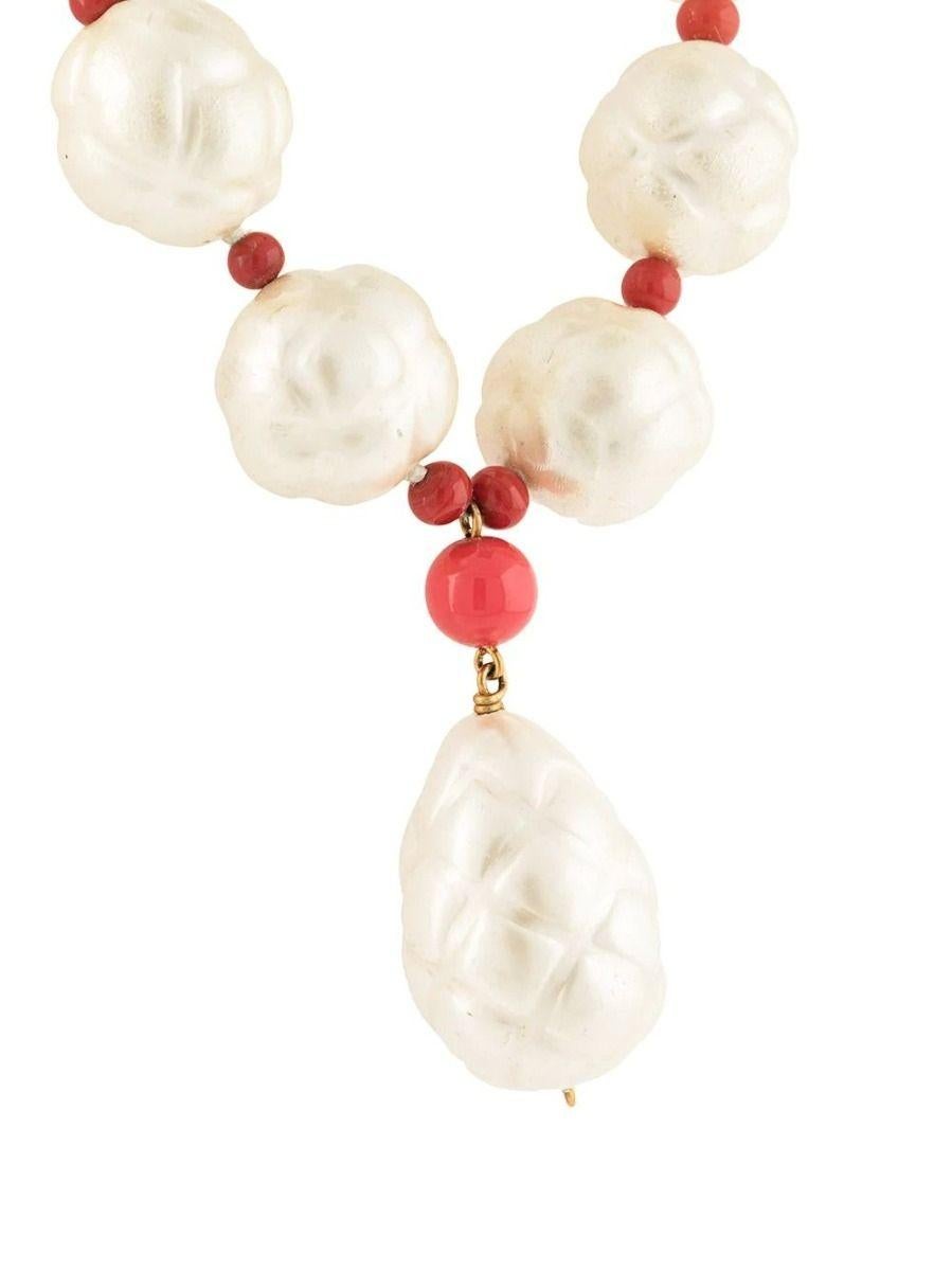 Resting at the collar bone, this Chanel necklace lights up the decolté with its lustrous finish. Featuring big faux pearls intertwined with smaller red beads, for an effect that feels classic, and yet highly extraordinary.

Colour: