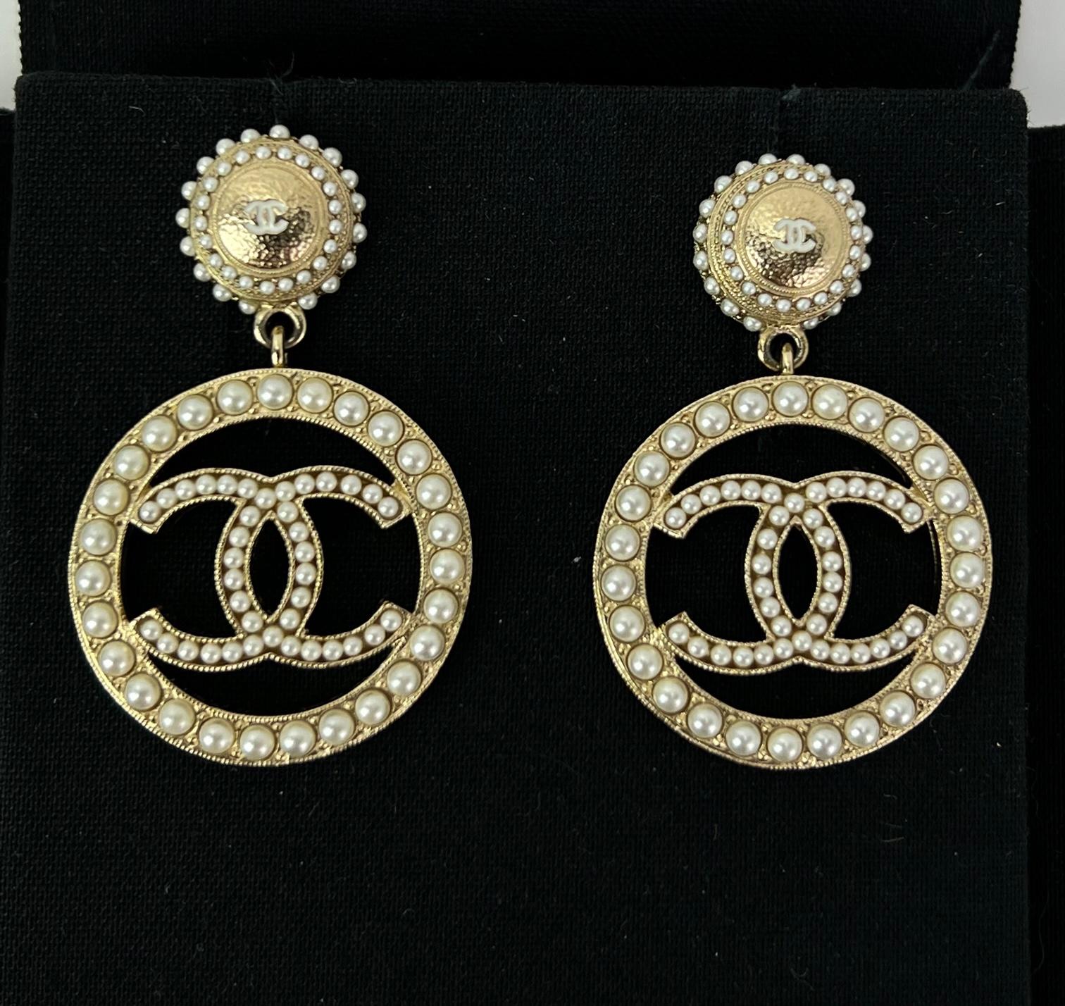 Pre-Owned 100% Authentic
CHANEL Earrings Pearl CC Logo Drop Golden Earrings
RATING: A...excellent, near mint, only slight 
signs of wear
MATERIAL: fancy mini pearl beads, metal
MEASUREMENTS: H 1.75'' x W 1.3''
BACKS: has plastic ring on backs for