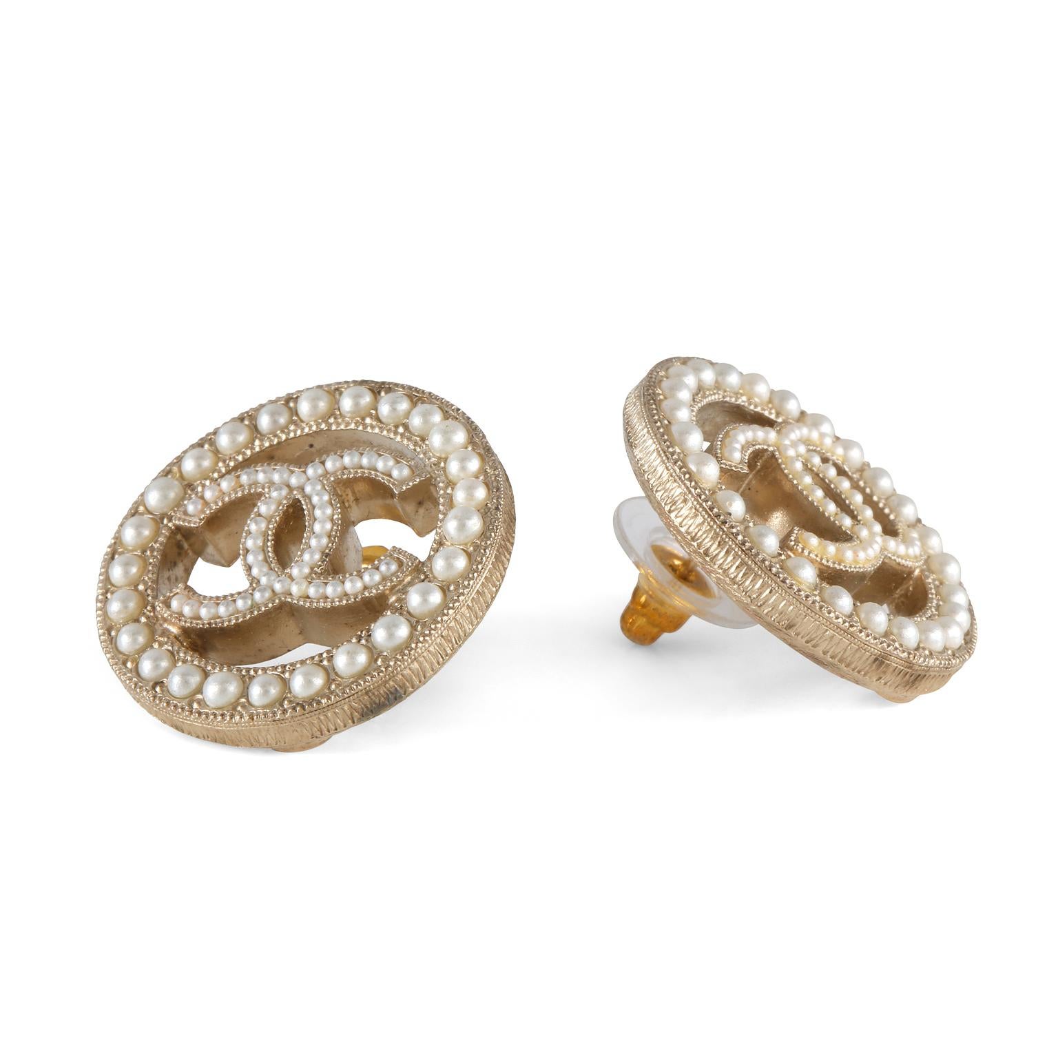 These authentic Chanel CC Pearl Earrings are in very good condition.  Open circles with dainty pearl surround and interlocking CC center.  Gold tone metal with post style closure.  Pouch or box included.

