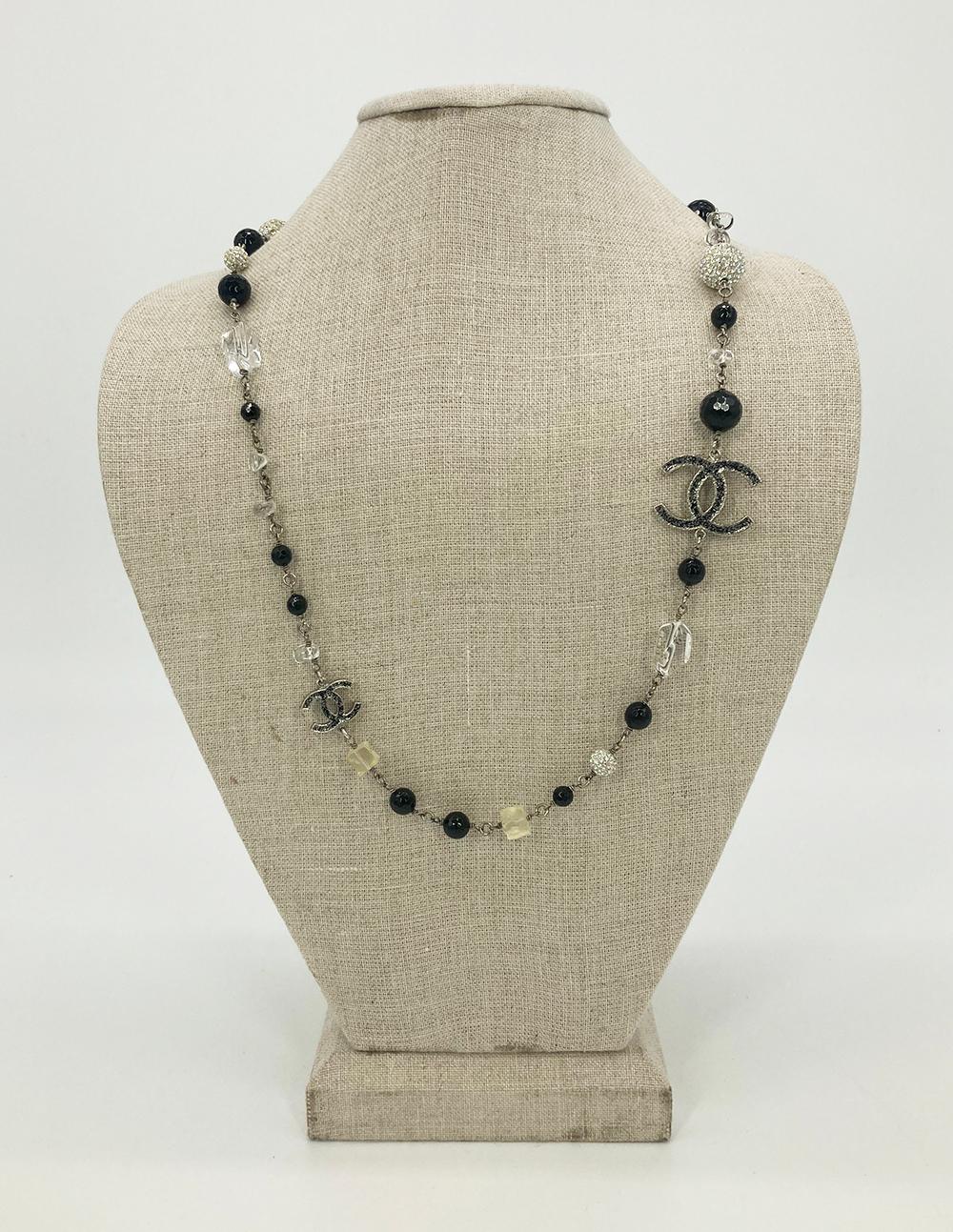 Chanel Pearl Crystal Beaded Necklace in excellent condition. Black pearls, clear crystal squares, clear crystal free form beads, round rhinestone embedded beads, and silver CC logos embossed with black glitter all strung together with silver