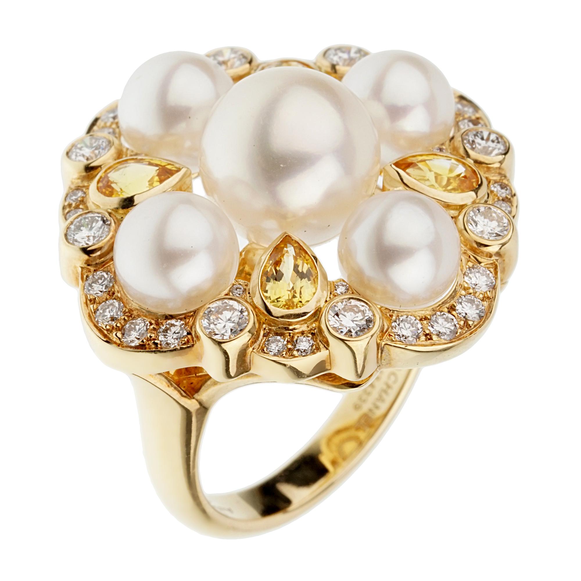 An incredible cocktail ring by Chanel showcasing 5 pearls adorned with 4 pear shaped yellow sapphires and diamond border all set in luxurious 18k yellow gold. The ring measures a size 6 1/2 and can be resized.