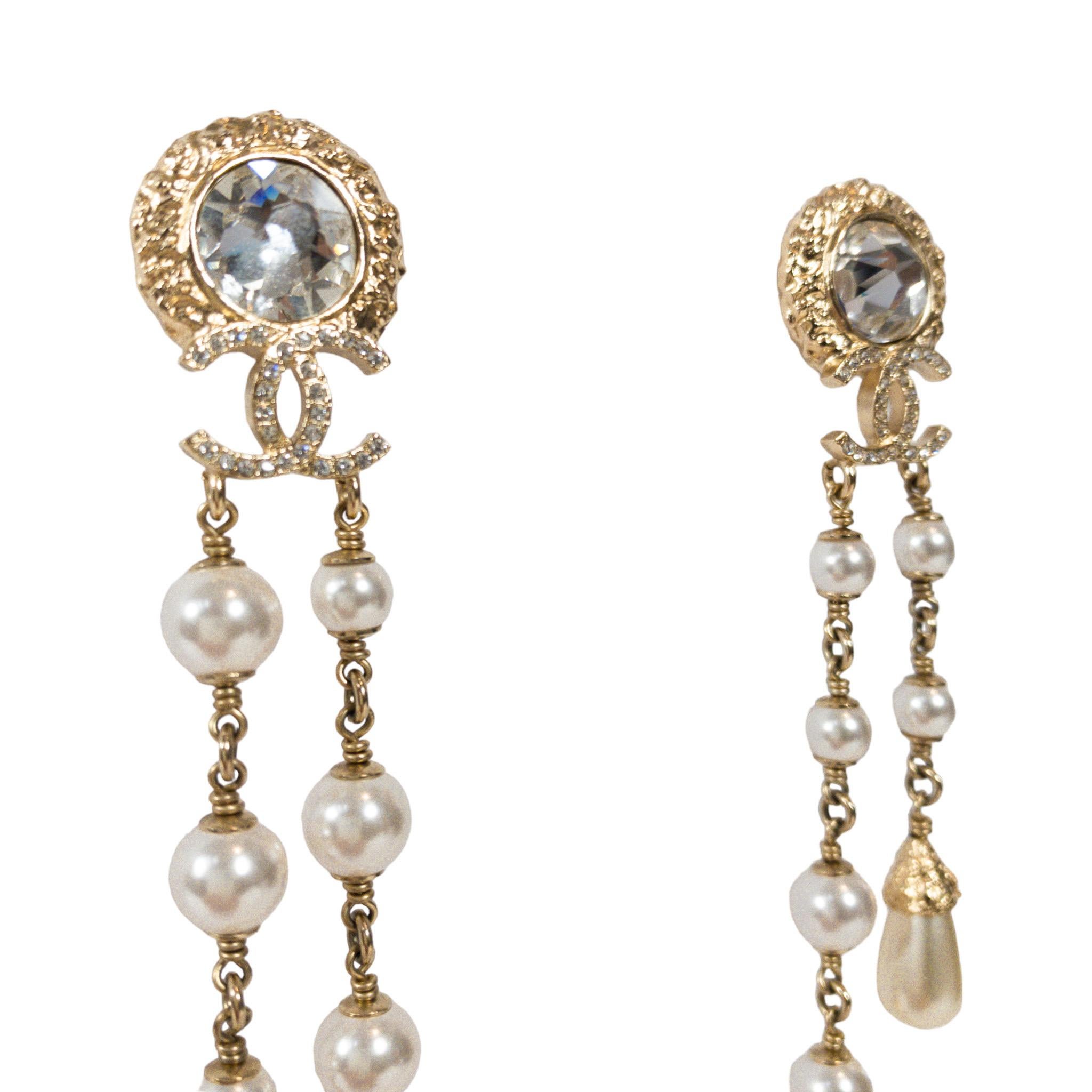 Consign of the Times presents these stunning Chanel Pearl Drop Asymetrical Chandelier Earrings. PIerced earrings with round backs. Large round crystal at center with CCs and tails of round and teardrop pearls at ends. 

Two strands each, unequal in