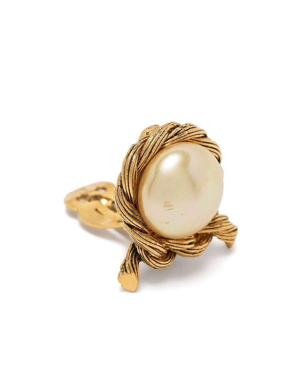 Add a little sophistication to your look with this pair of earrings by Chanel, crafted in France from gold-toned brass hardware. These earrings feature a luminous faux-pearl embellishment for optimum elegance and finished with a comfortable, rear