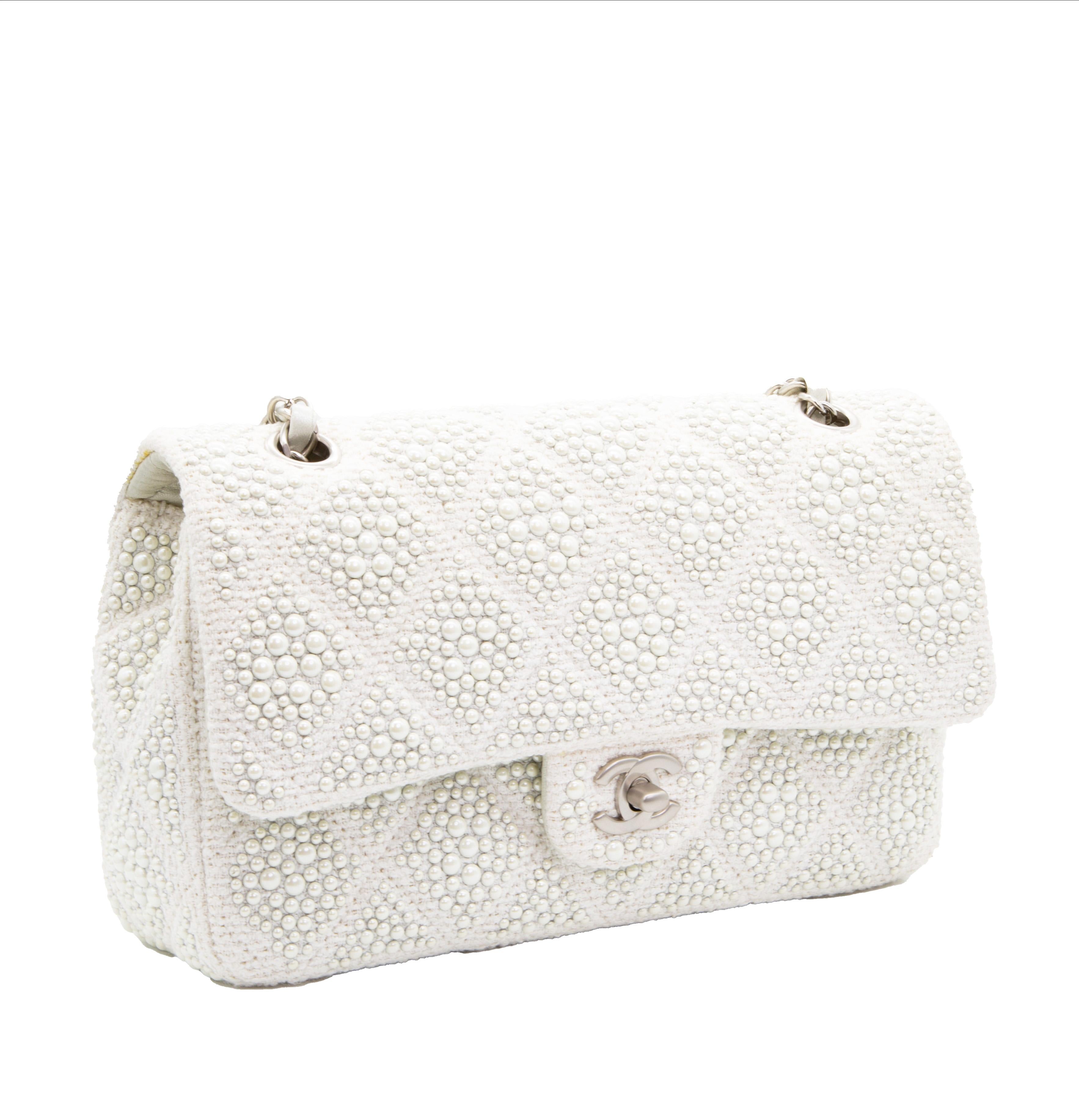 This pearl white Chanel bag from the Spring Summer 2015 collection is a playful yet classy version of the classic Chanel flap bag. The combination of the iconic shape and the delicate pearl embellishments, which are a historic part of Chanel brand,