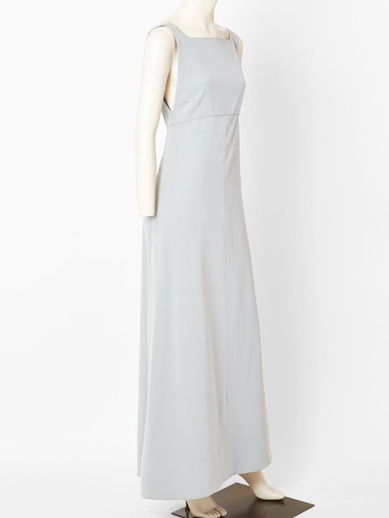 Chanel, ultra simple, evening dress in a pearl grey tone, having an empire waist and an A line silhouette. Dress is made of a heavy viscose crepe and lined in a black jersey. Back of the dress has a bias cut 
