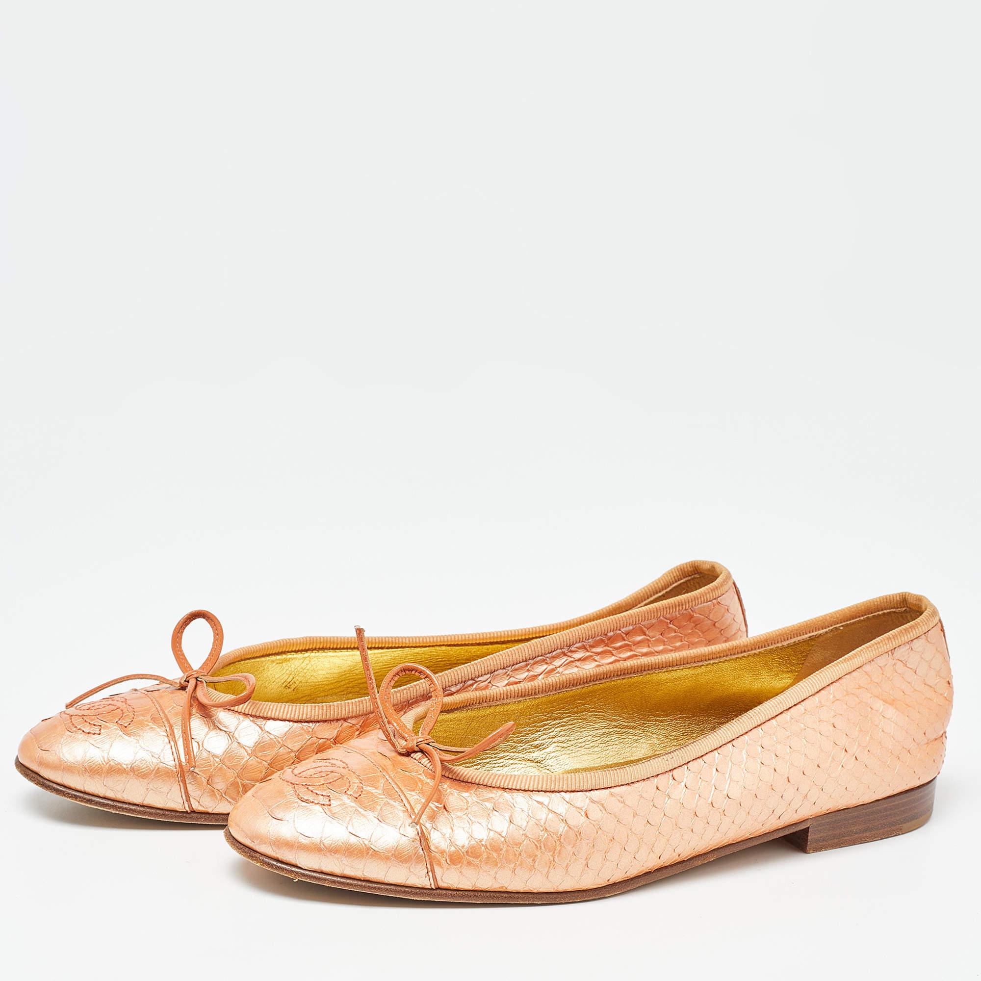 A common sight in the closets of fashionistas is a pair of Chanel ballet flats. They are perfect to wear on busy days and just stylish enough to assist one's style. These are crafted from python leather and feature the CC logo and bow details.

