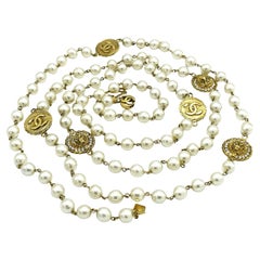 CHANEL PEARL SAUTOIR, 6 double-sided coins with CC logos and lion heads 1982's