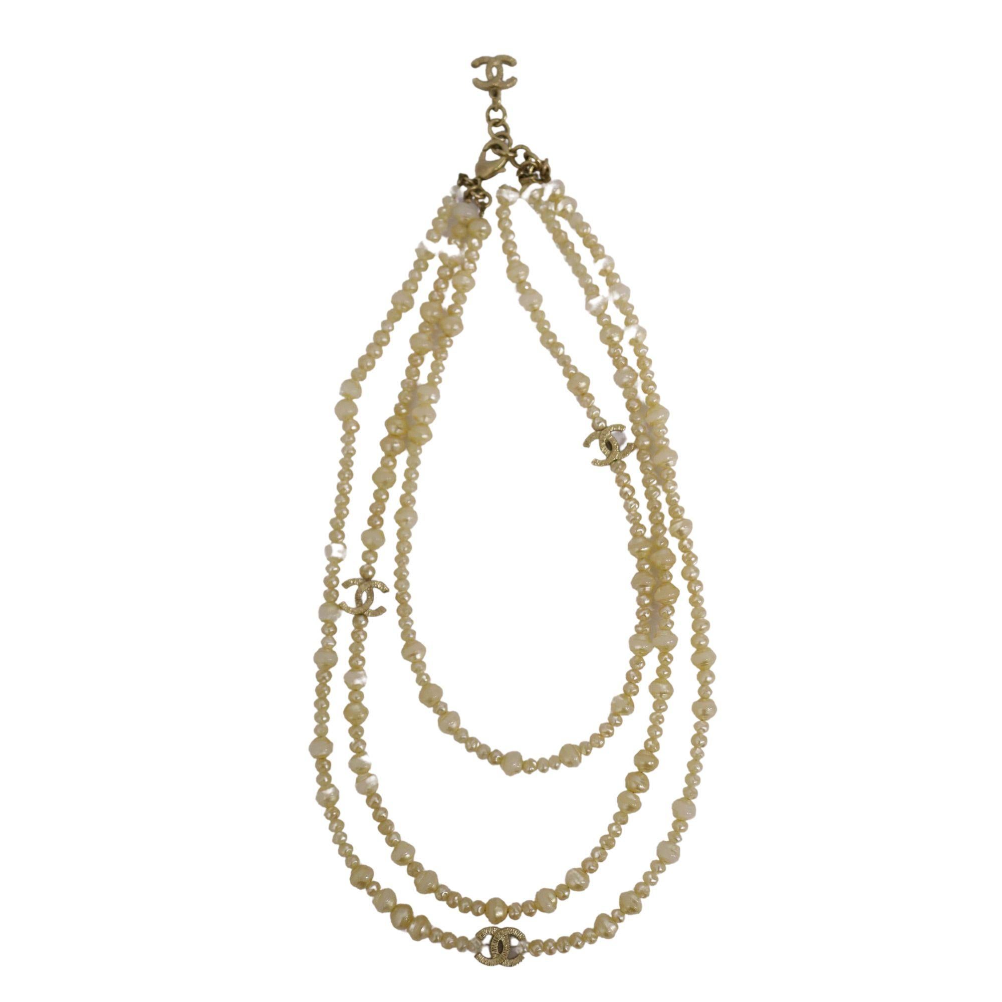 Layered Chanel pearl necklace with gold Chanel CC logo details  . Minor peeling of pearls throughout.

Measurements: 
Strand Drop
Shortest: 22cm
Middle: 27cm
Longest: 30

Condition: Good, pearl peeling (refer to photos)