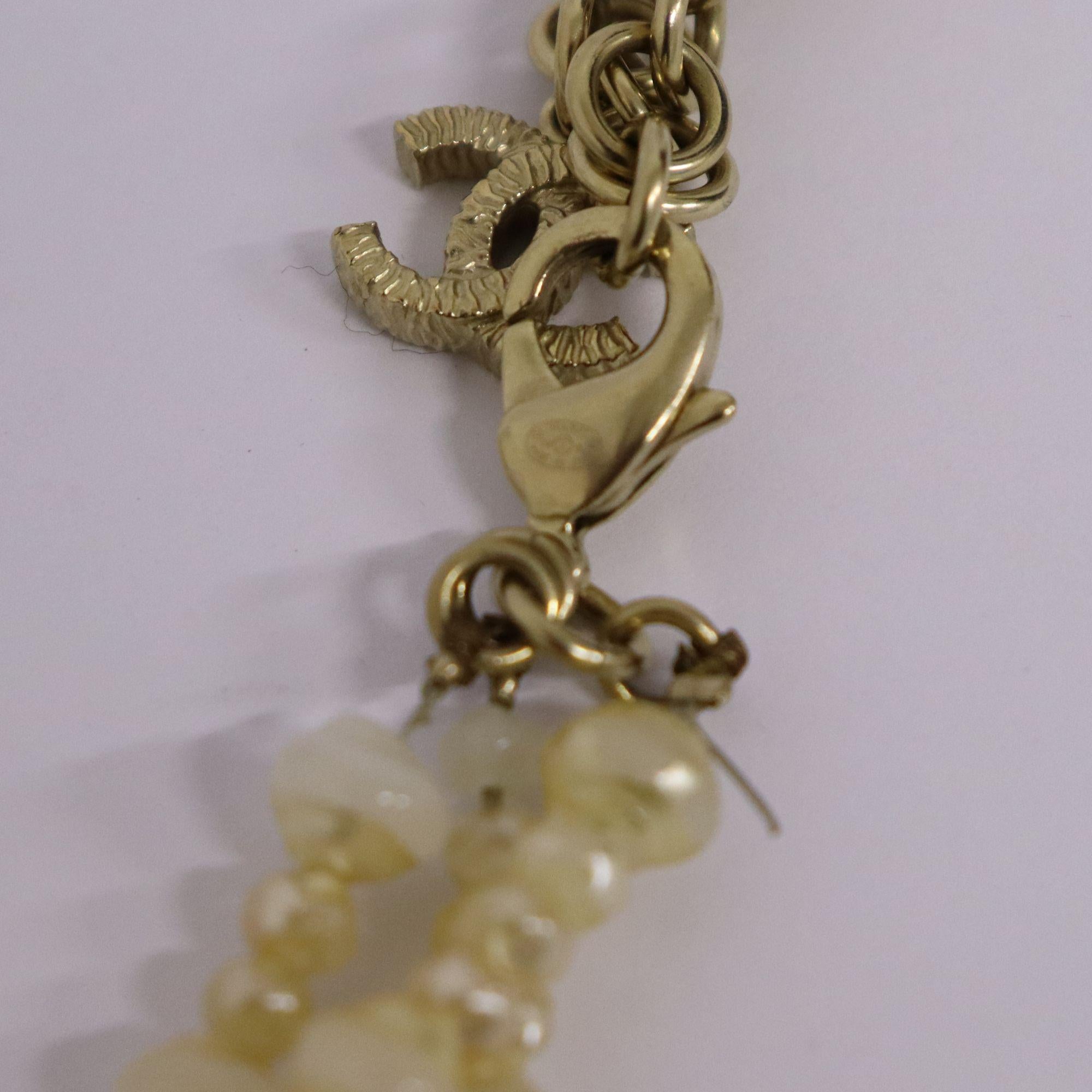 Contemporary Chanel Pearl Triple Strand Necklace with CC Logo