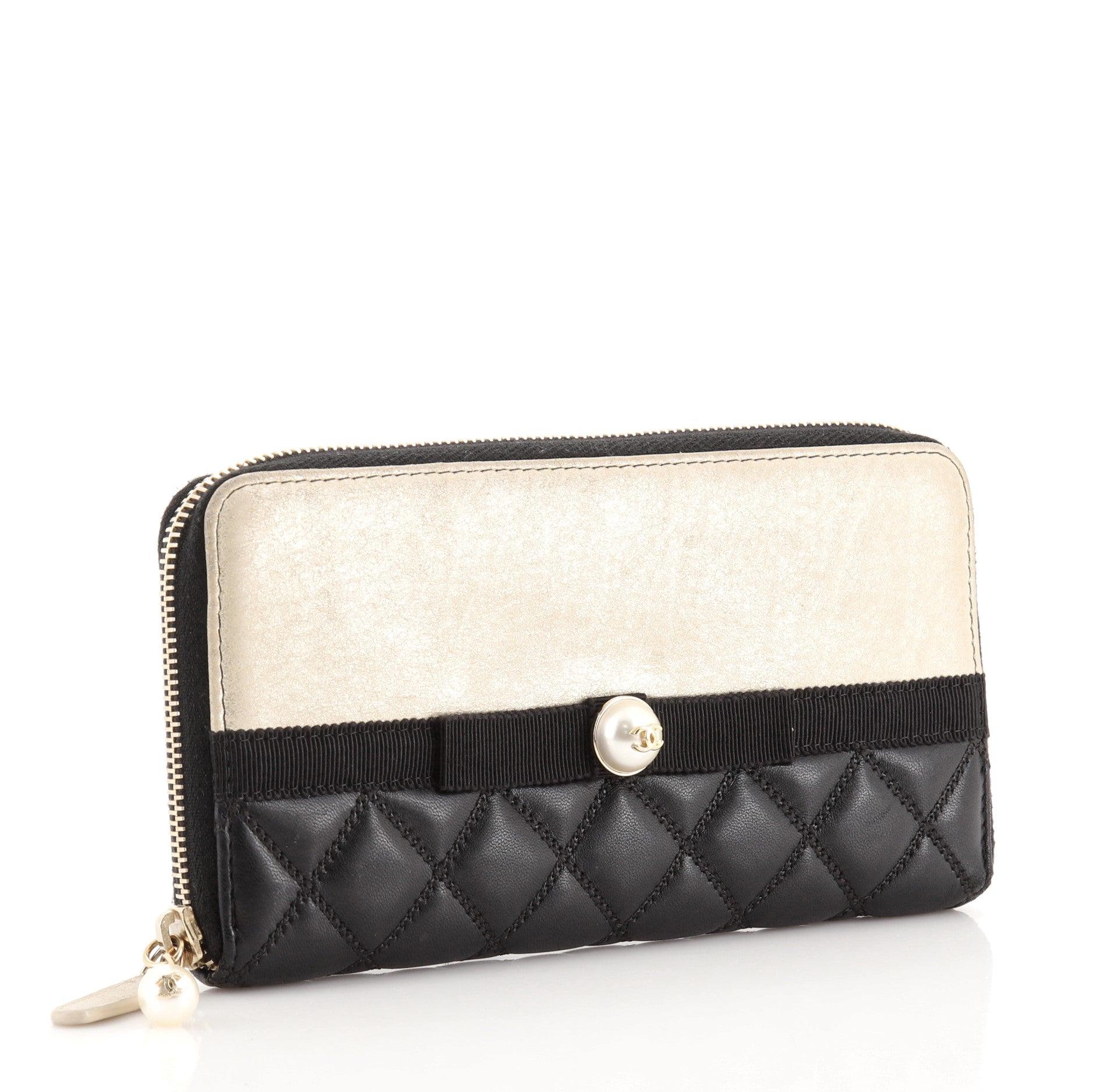 Chanel Pearl Zip Wallet Lambskin Long
Black Neutral Wallet

Condition Details: Heavy wear and discoloration on exterior edges and front, scuffs and wear on exterior and in interior, pilling on zipper tape. Cracking and peeling on zipper pull wax