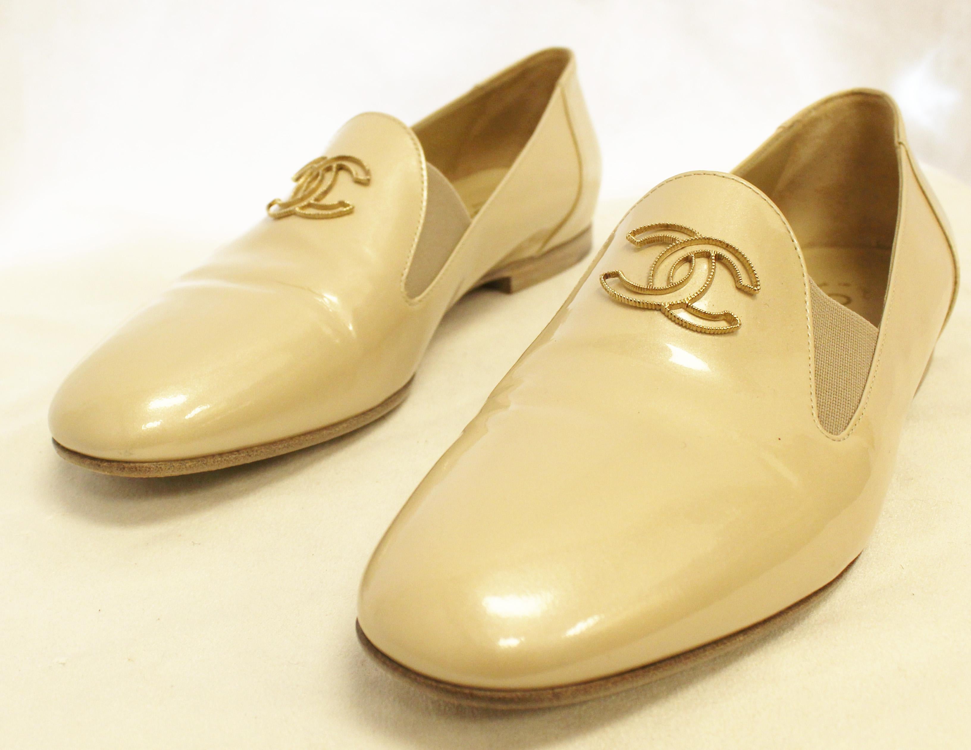 Chanel pearlized beige patent leather flats with round toe with gold tone interlocking CC logo on upper of loafers really portray Coco's style.  In excellent shape, unusual to get into the shop!.  