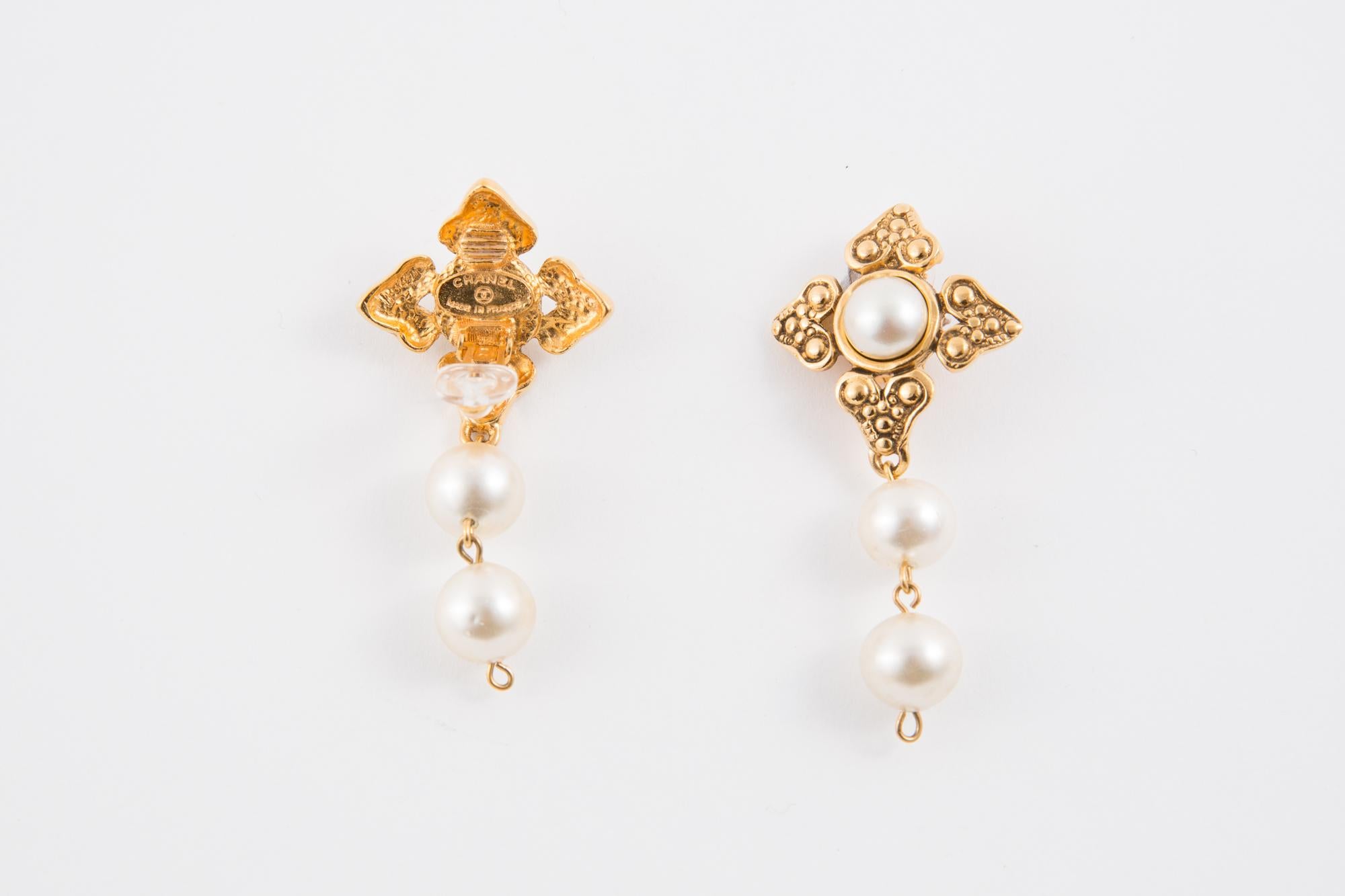 Chanel drop clip-on earrings featuring faux pearl beads, gold-tone metal, and a logo back plaque.  
These earrings come as a pair. 
In good vintage condition  Made in France. 
Maxi Length: 2.3in. (6cm)
We guarantee you will receive this gorgeous