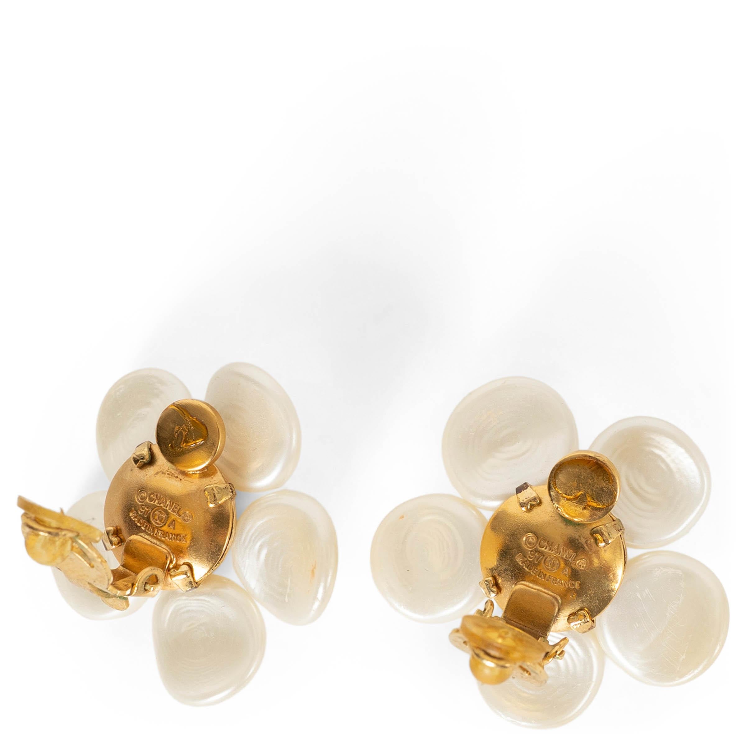 These 100% authentic Chanel clip-on earrings are crafted in pearly white imitation pearls sculpted into the house’s signature Camellia flower. A beautifully feminine and timeless design, they capture the elegant softness of Chanel’s most iconic