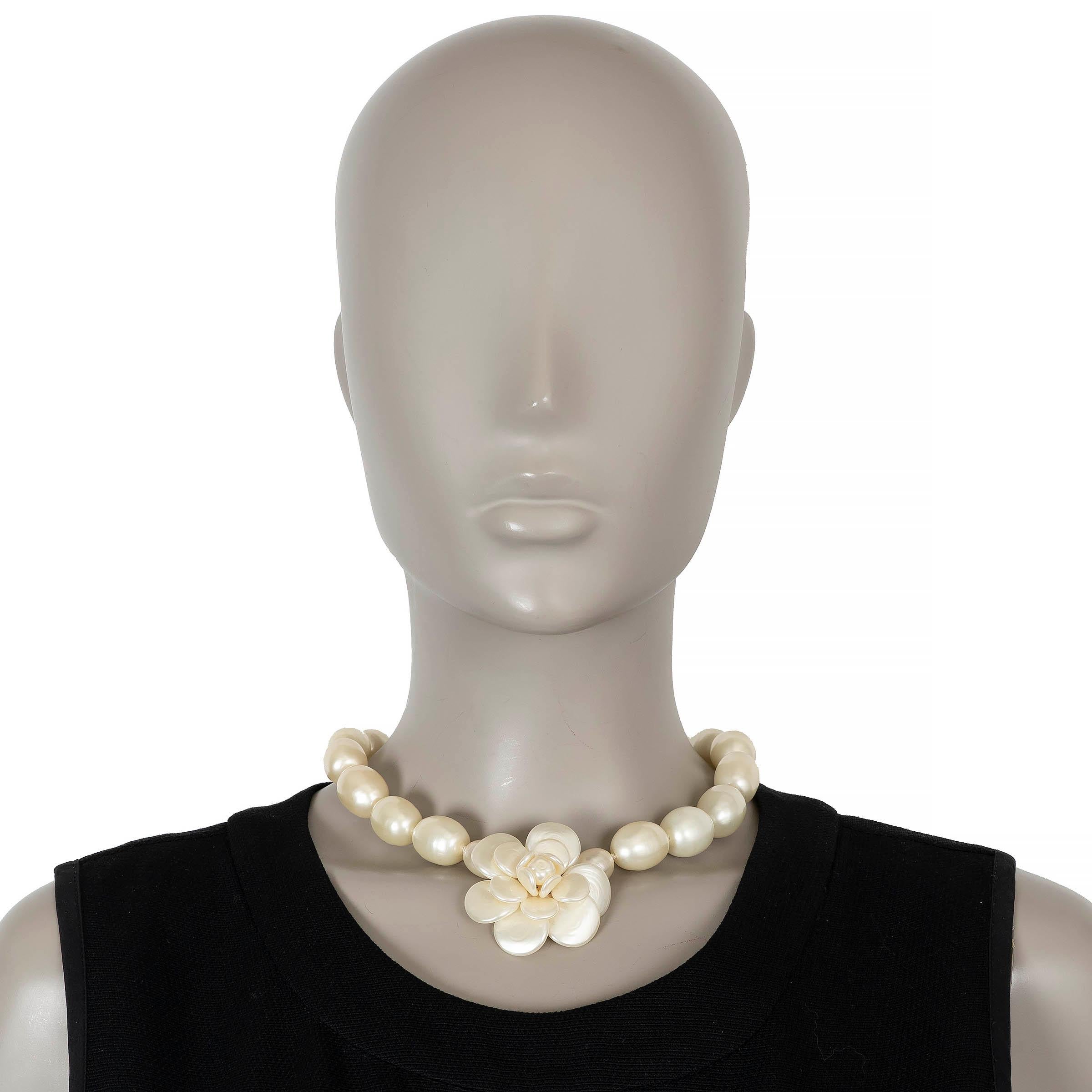 These 100% authentic Chanel choker necklace is crafted from oversized pearly white imitation pearls and centered with a sculptural Camellia—one of the house’s most iconic emblems. Finished with a hook-and-chain closure for adjustable length, this