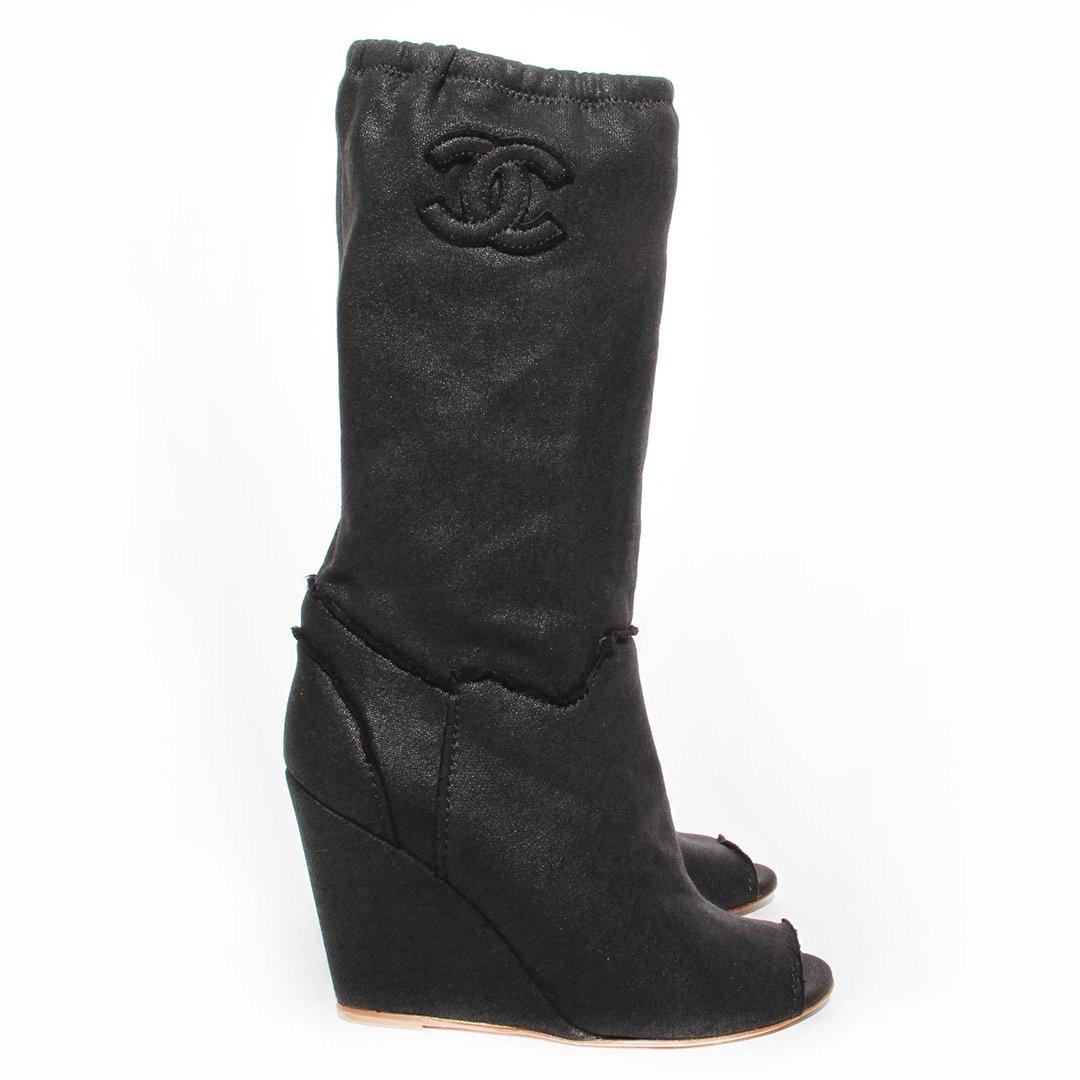 Chanel Peep-Toe Bootie
Resort 2008
Made in Italy
Black waxed cotton 
Exposed seem detailing around ankle of bootie
Elasticized detailing at top of bootie
Interlocked CC detail on outside of each bootie
Peep-Toe detail
Wedge style